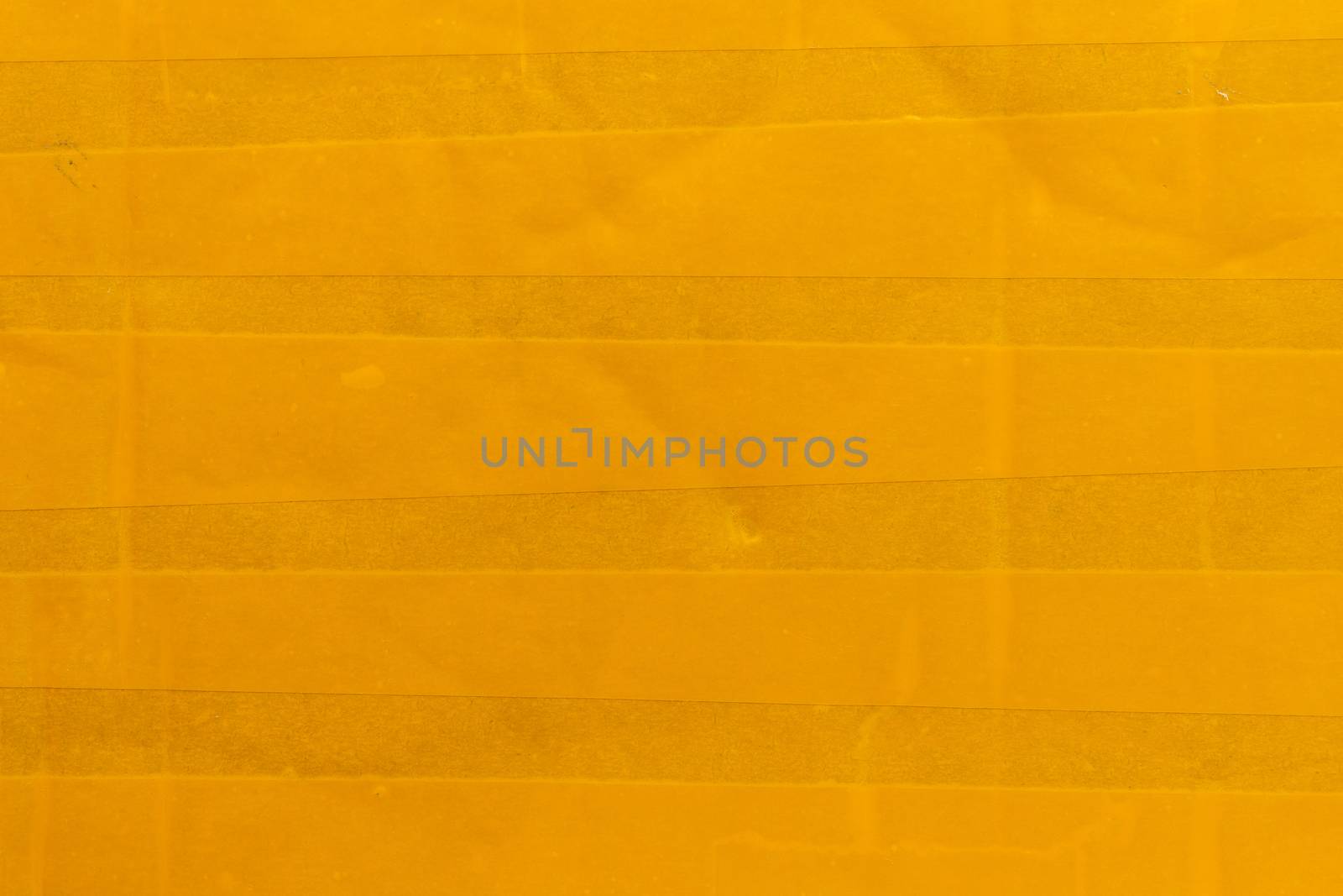 yellow sticky tape wrapped flat surface texture and close-up background.