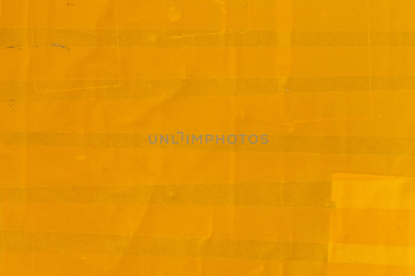 yellow sticky tape wrapped flat surface texture and close-up background.