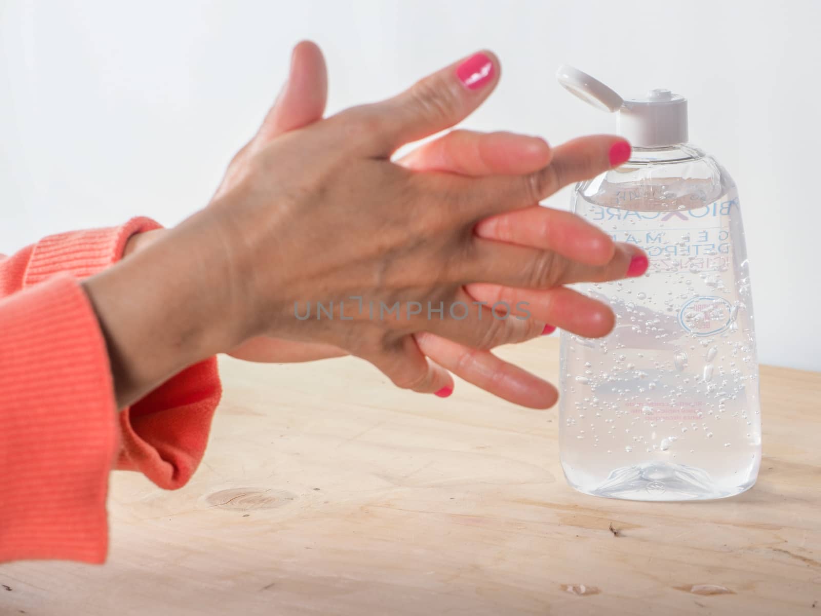 close up of  woman hands while cleaning and sanitizing  herself  by verbano