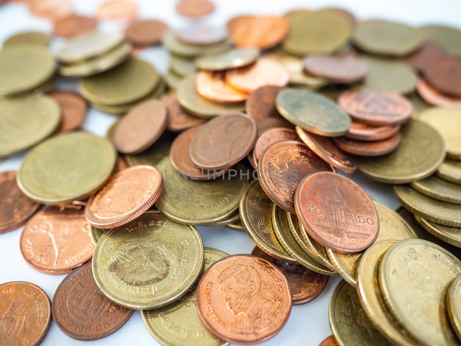 Thai Baht Coins colors Gold set in the mountains,Is the currency of Thailand.For business expenses,Coin is in a jar of money saving,White background