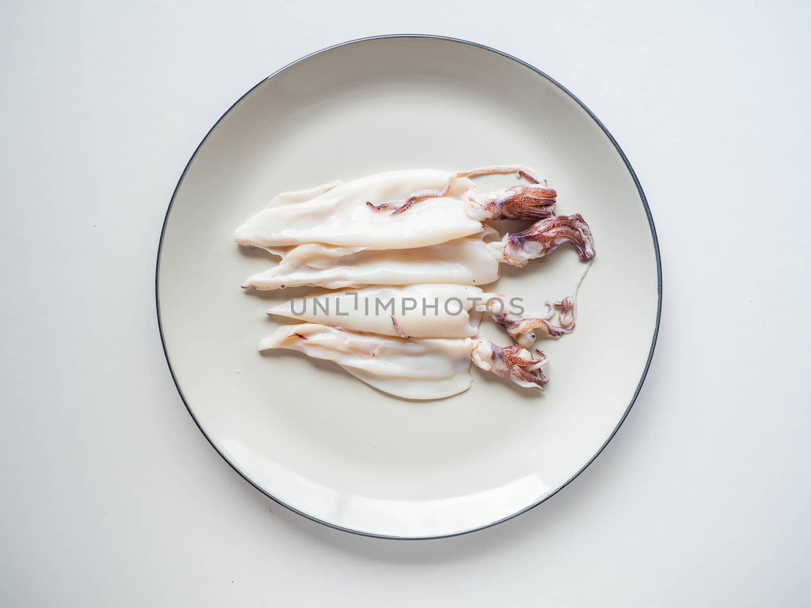 Fresh squid Topping
black pepper from the market on dish White and White background
