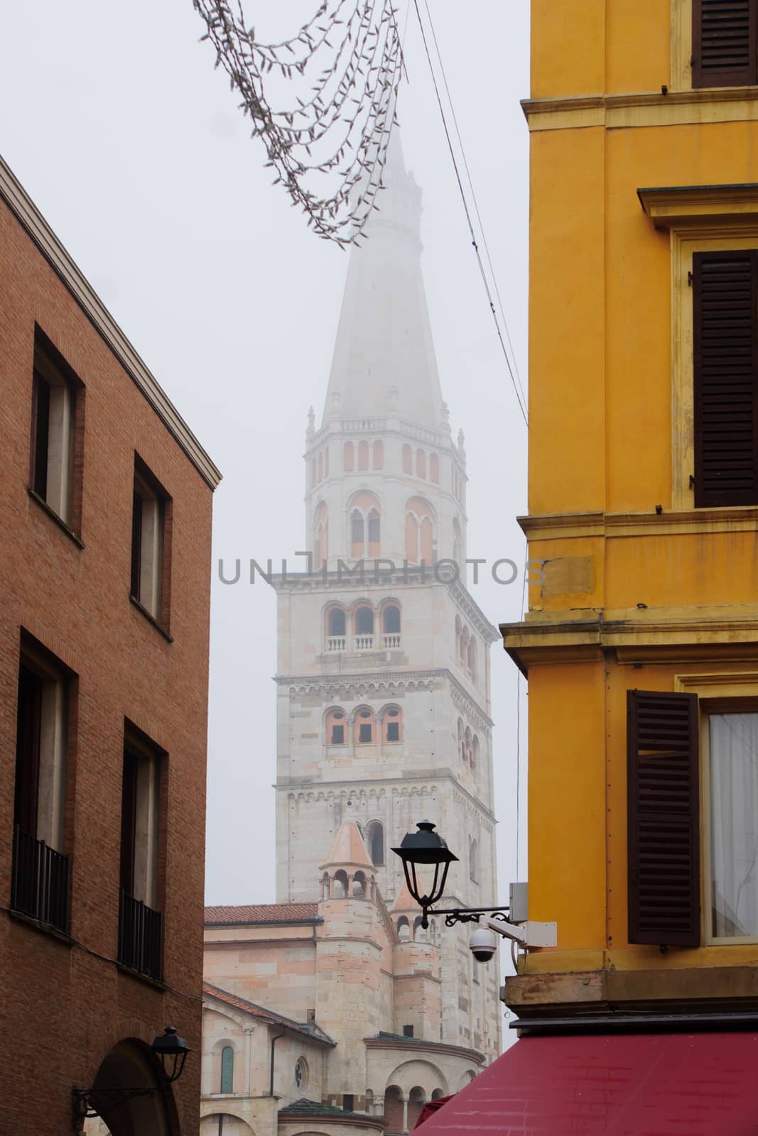 The Duomo tower and street scene in the historic center of Modena, Emilia-Romagna, Italy