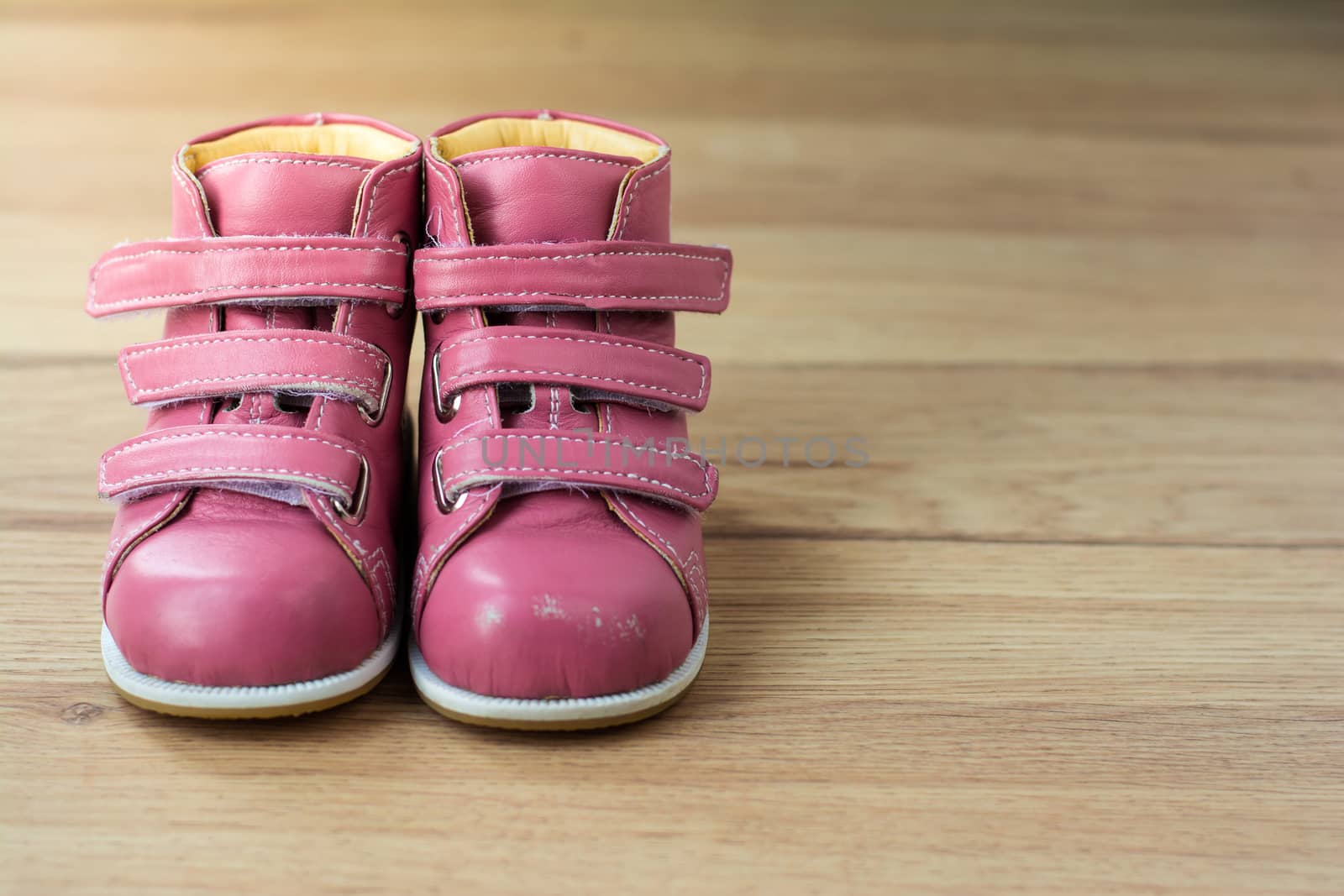 Pink Kids Shoes on wood background,Children's leather boots by jateshutter