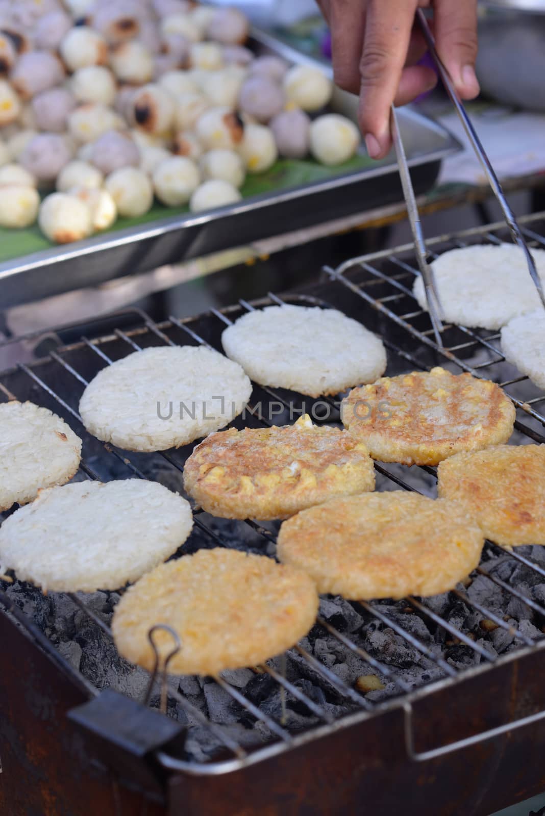 Round flat glutinous rice grilled over charcoal grills