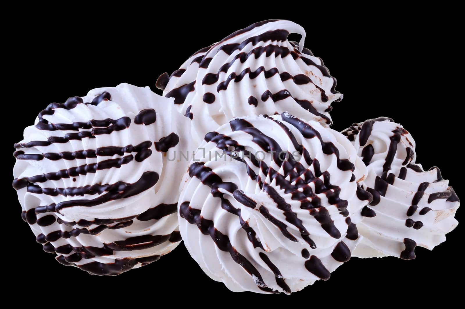 Meringue with chocolate closeup isolated on black background.