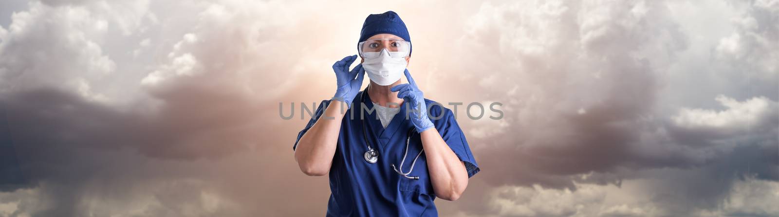 Doctor or Nurse Adjusting Medical Face Mask Wearing Personal Protective Equipment Over Ominous Clouds.