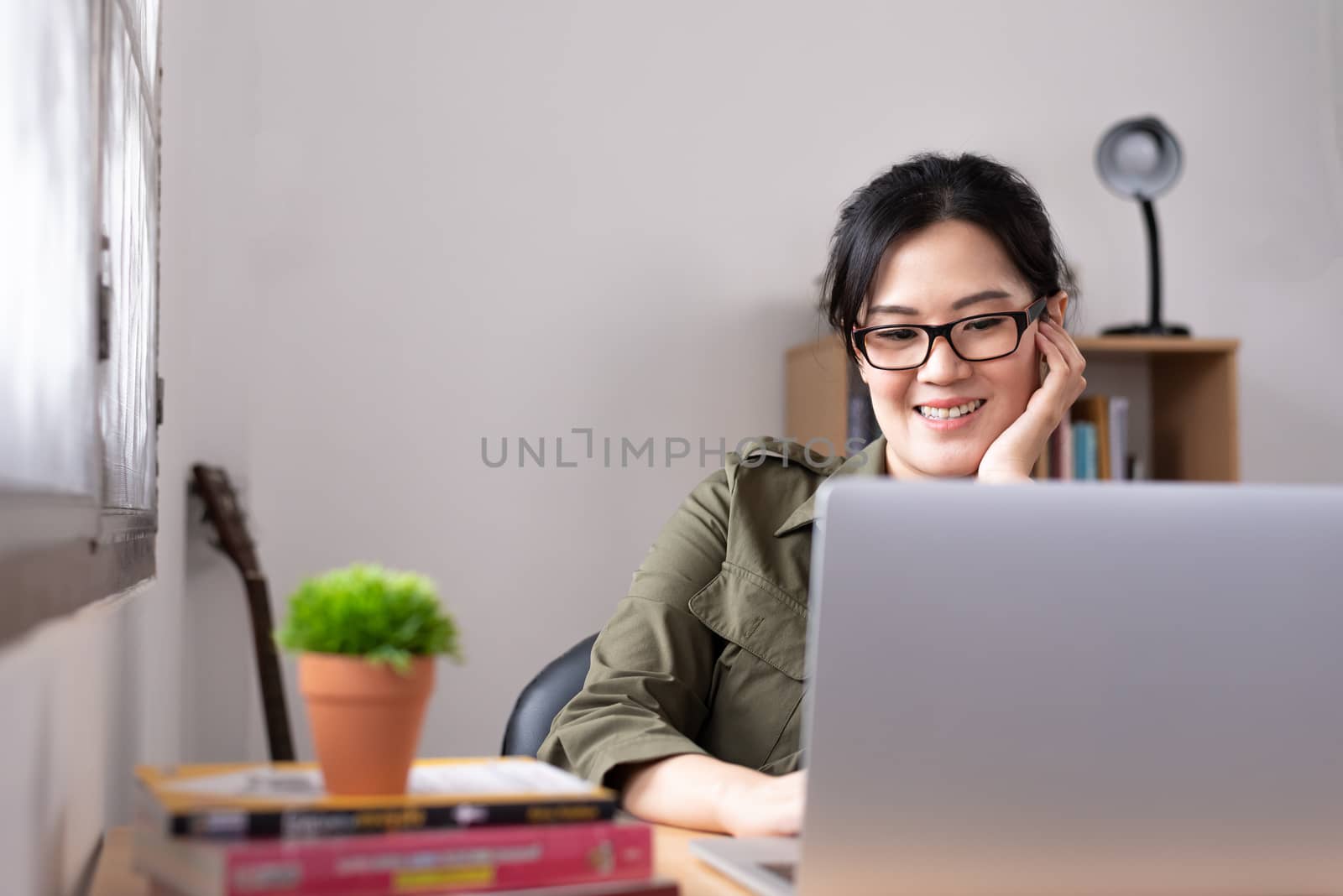 Modern young Asian woman working from home with happy, smile and relax.