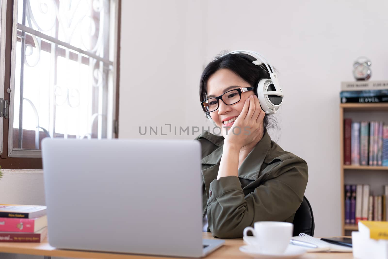 Modern young Asian woman working from home with happy, smile, and relax..