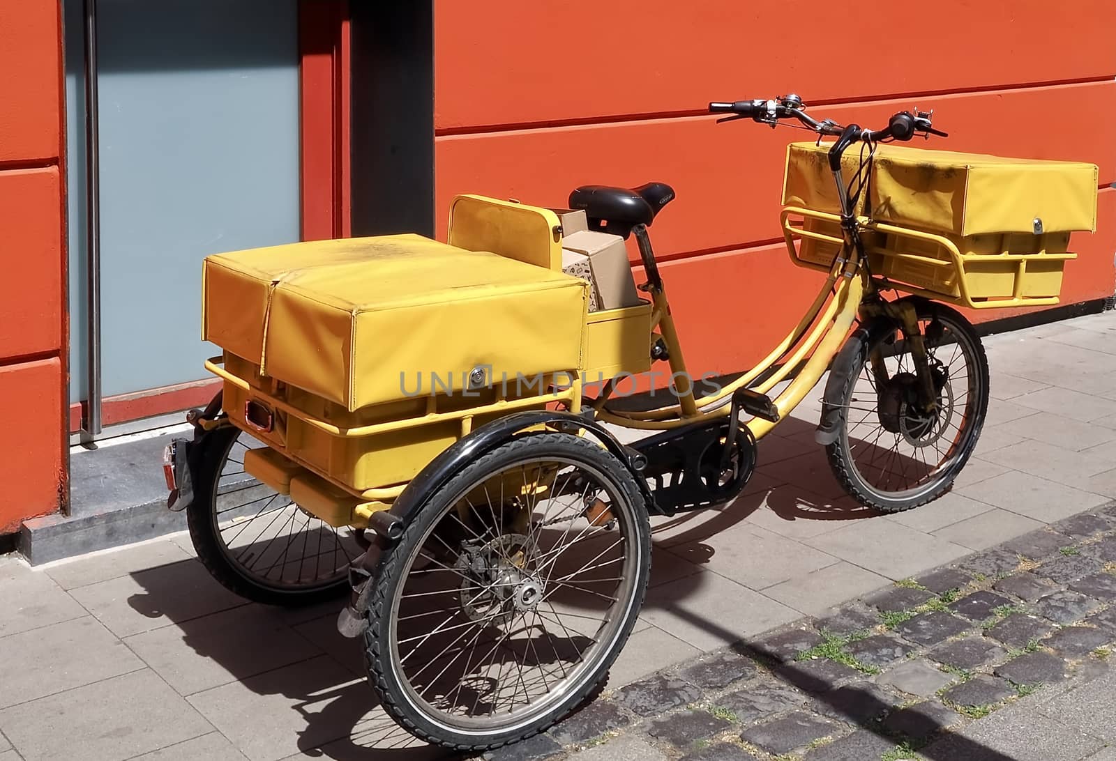 Yellow Bicycle of a post man packed with letters and parcels