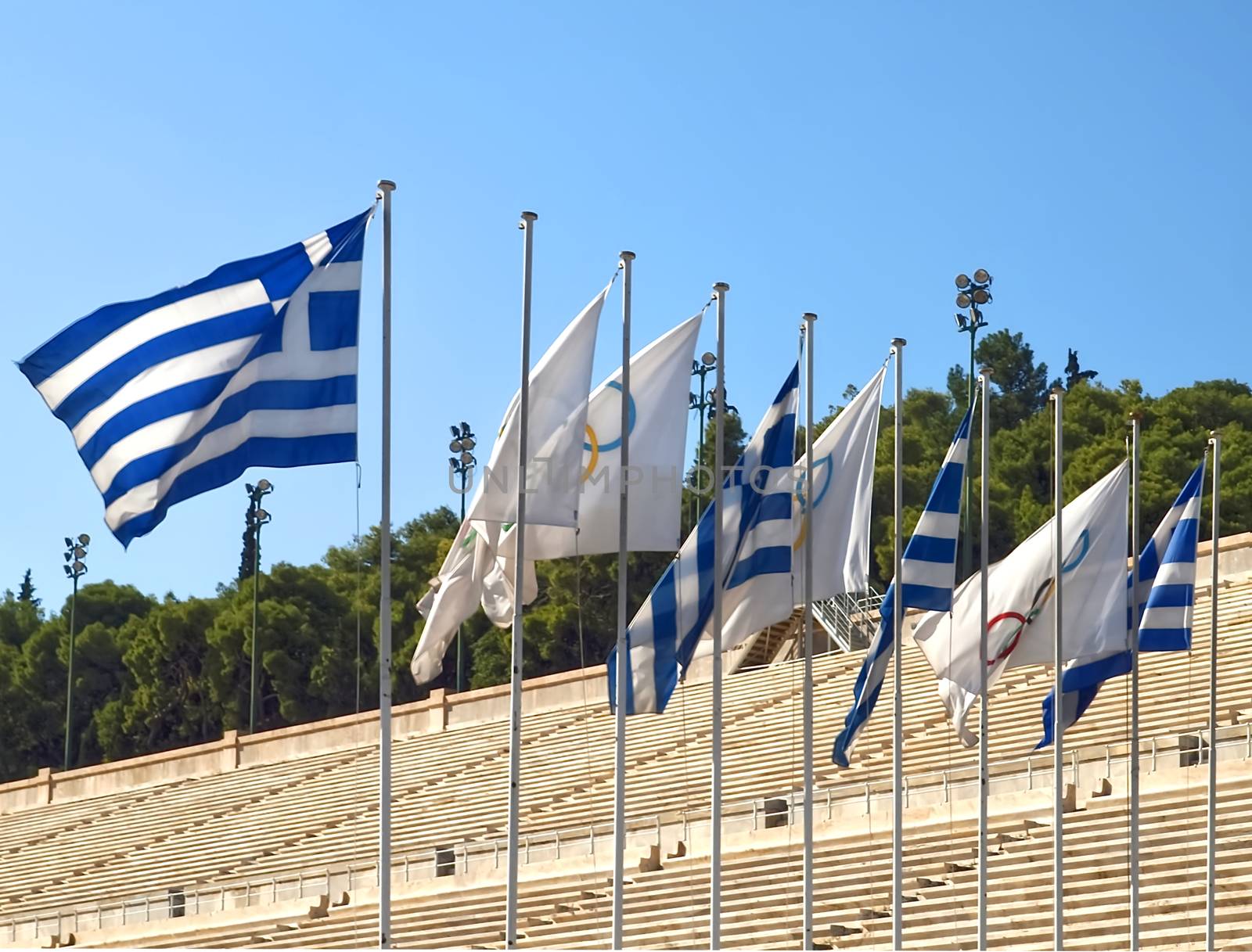 The historic olympic stadium with flags in Athens by Stimmungsbilder