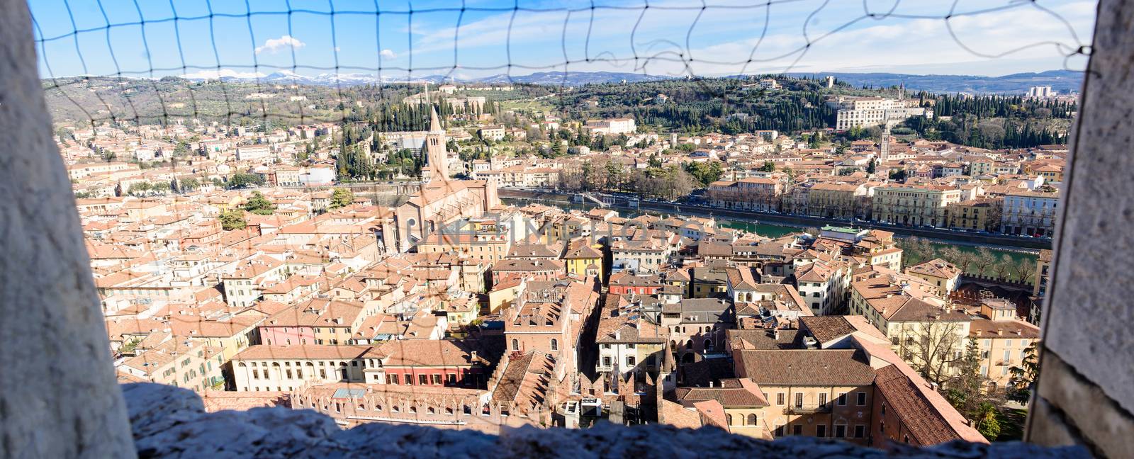 Panoramic view of the historic center of Verona, via a net in the window of the Torre dei Lamberti tower, in Verona, Veneto, Italy