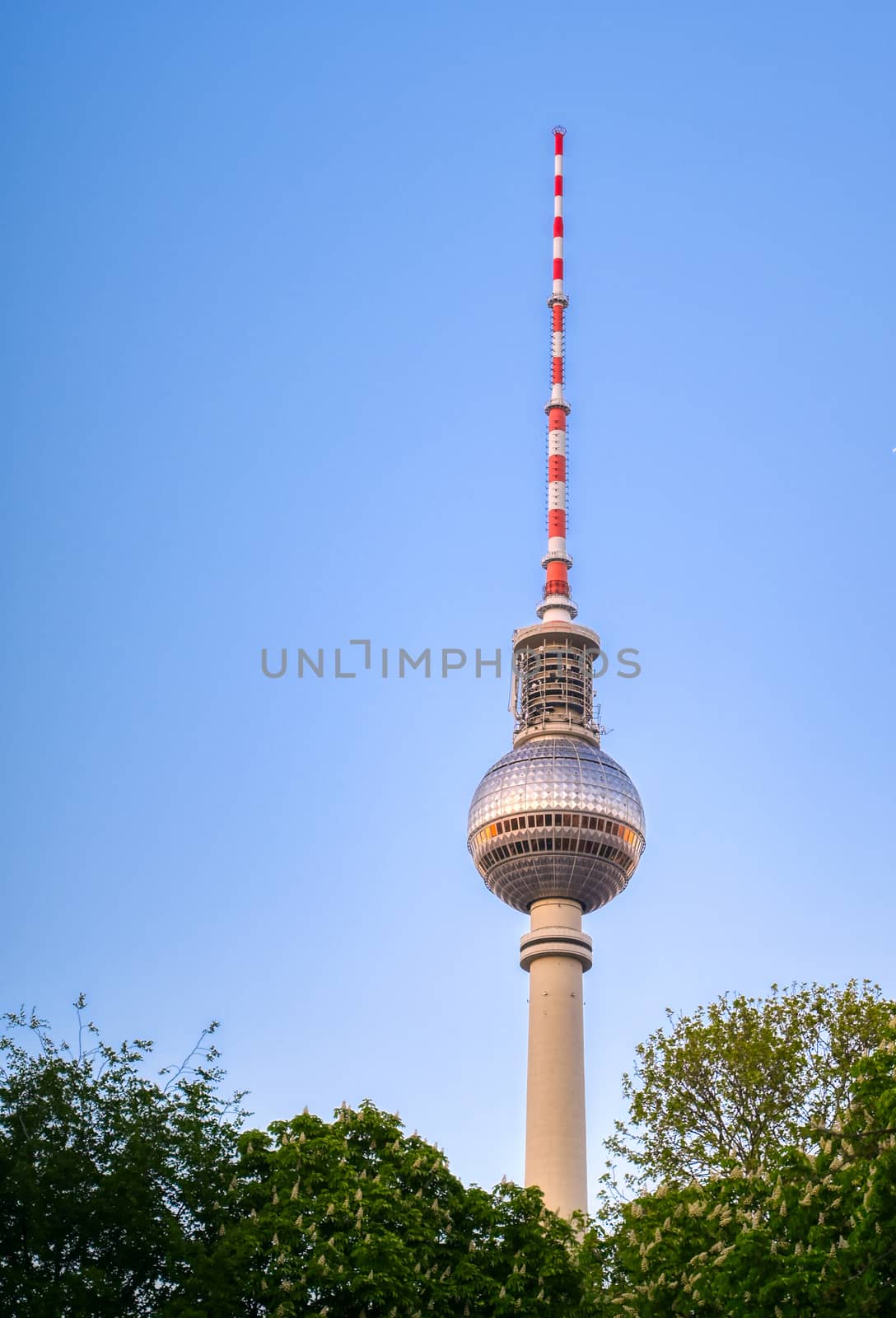 A view of the television tower (Fernsehturm) over the city of Berlin, Germany at sunset.