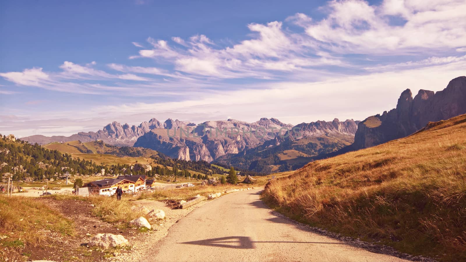 Trentino Alto - Adige, Italy - 06/15/2020: cenic alpine place with magical Dolomites mountains in background, amazing clouds and blue sky in Trentino Alto Adige region, Italy, Europe