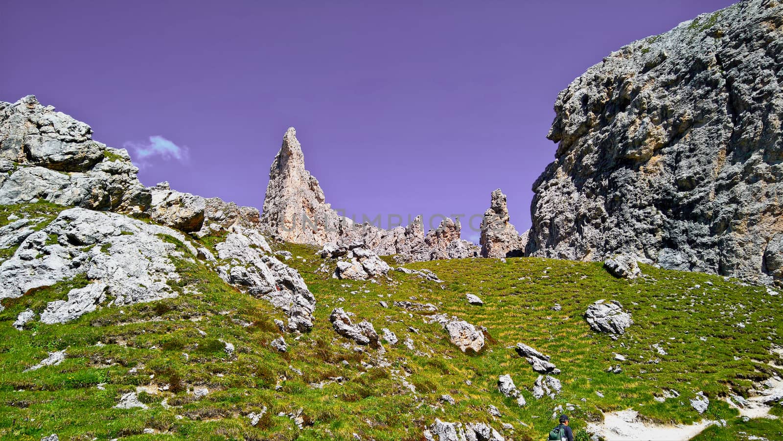 Trentino Alto - Adige, Italy - 06/15/2020: cenic alpine place with magical Dolomites mountains in background, amazing clouds and blue sky in Trentino Alto Adige region, Italy, Europe