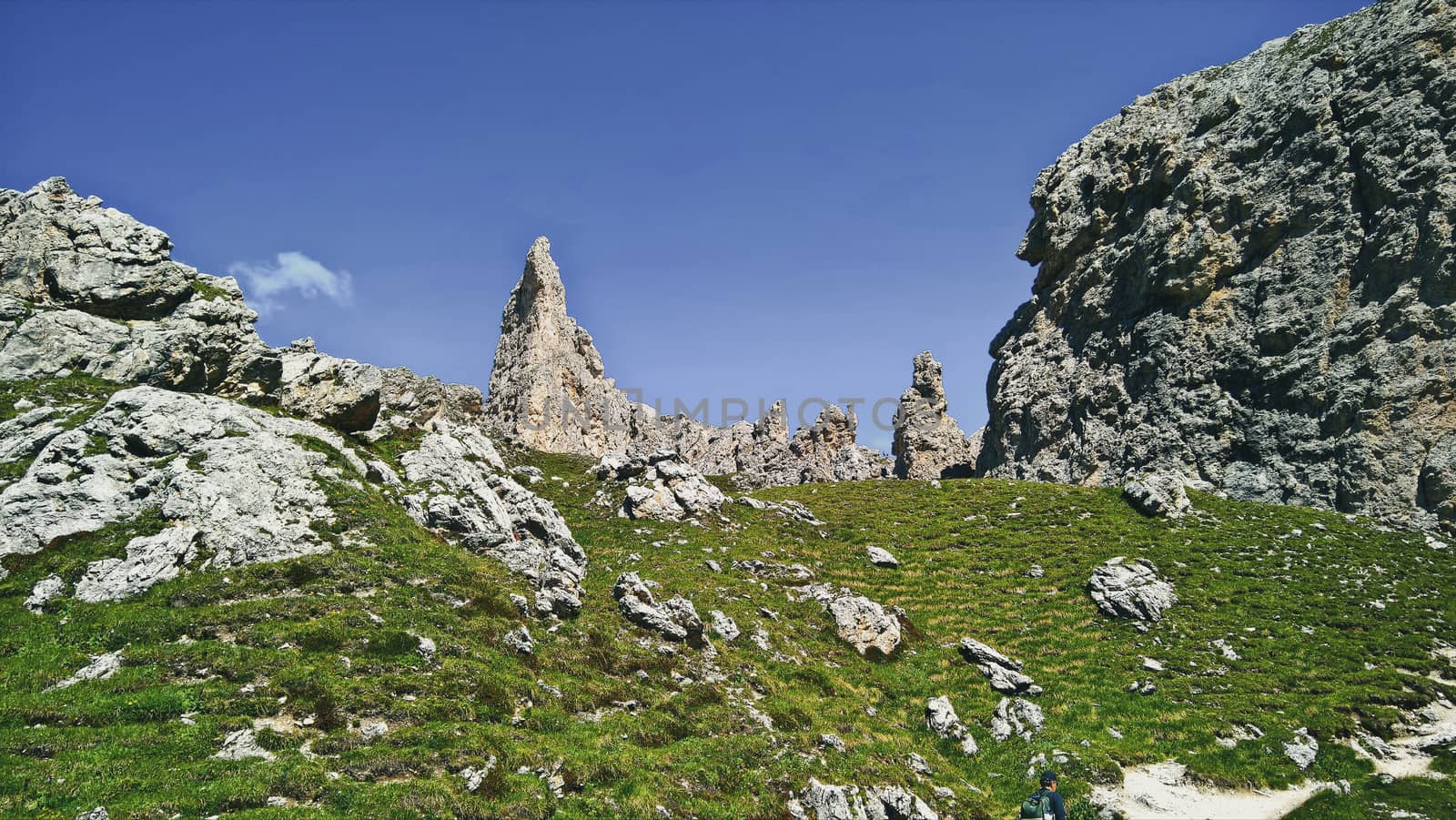 Trentino Alto - Adige, Italy - 06/15/2020: cenic alpine place with magical Dolomites mountains in background, amazing clouds and blue sky in Trentino Alto Adige region, Italy, Europe