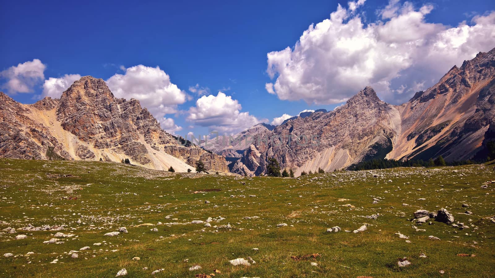 Trentino Alto - Adige, Italy - 06/15/2020: cenic alpine place with magical Dolomites mountains in background, amazing clouds and blue sky in Trentino Alto Adige region, Italy, Europe