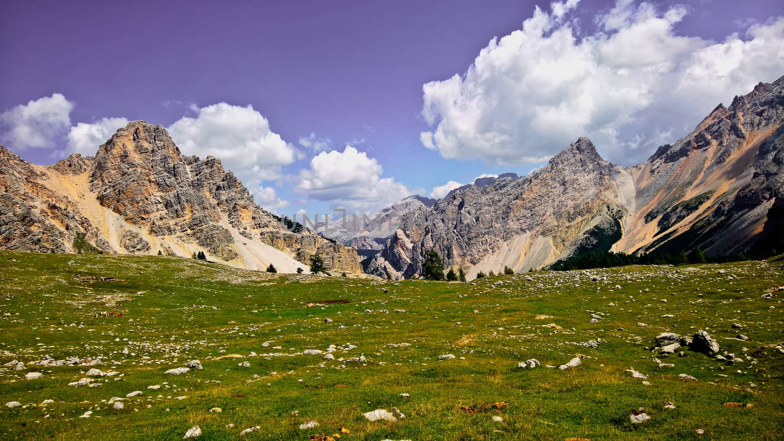 Trentino Alto - Adige, Italy - 06/15/2020: cenic alpine place with magical Dolomites mountains in background, amazing clouds and blue sky in Trentino Alto Adige region, Italy, Europe