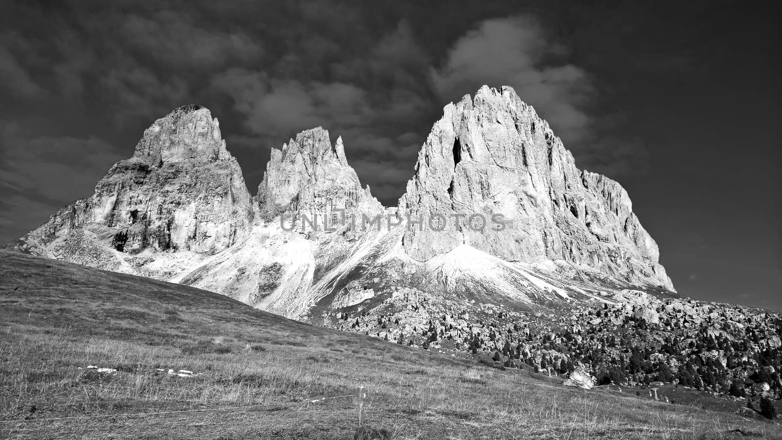 Trentino Alto - Adige, Italy - 06/15/2020: cenic alpine place with magical Dolomites mountains in background, amazing clouds and blue sky in Trentino Alto Adige region, Italy, Europe