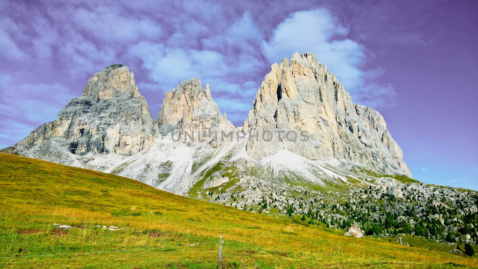 Trentino Alto - Adige, Italy - 06/15/2020: cenic alpine place with magical Dolomites mountains in background, amazing clouds and blue sky in Trentino Alto Adige region, Italy, Europe