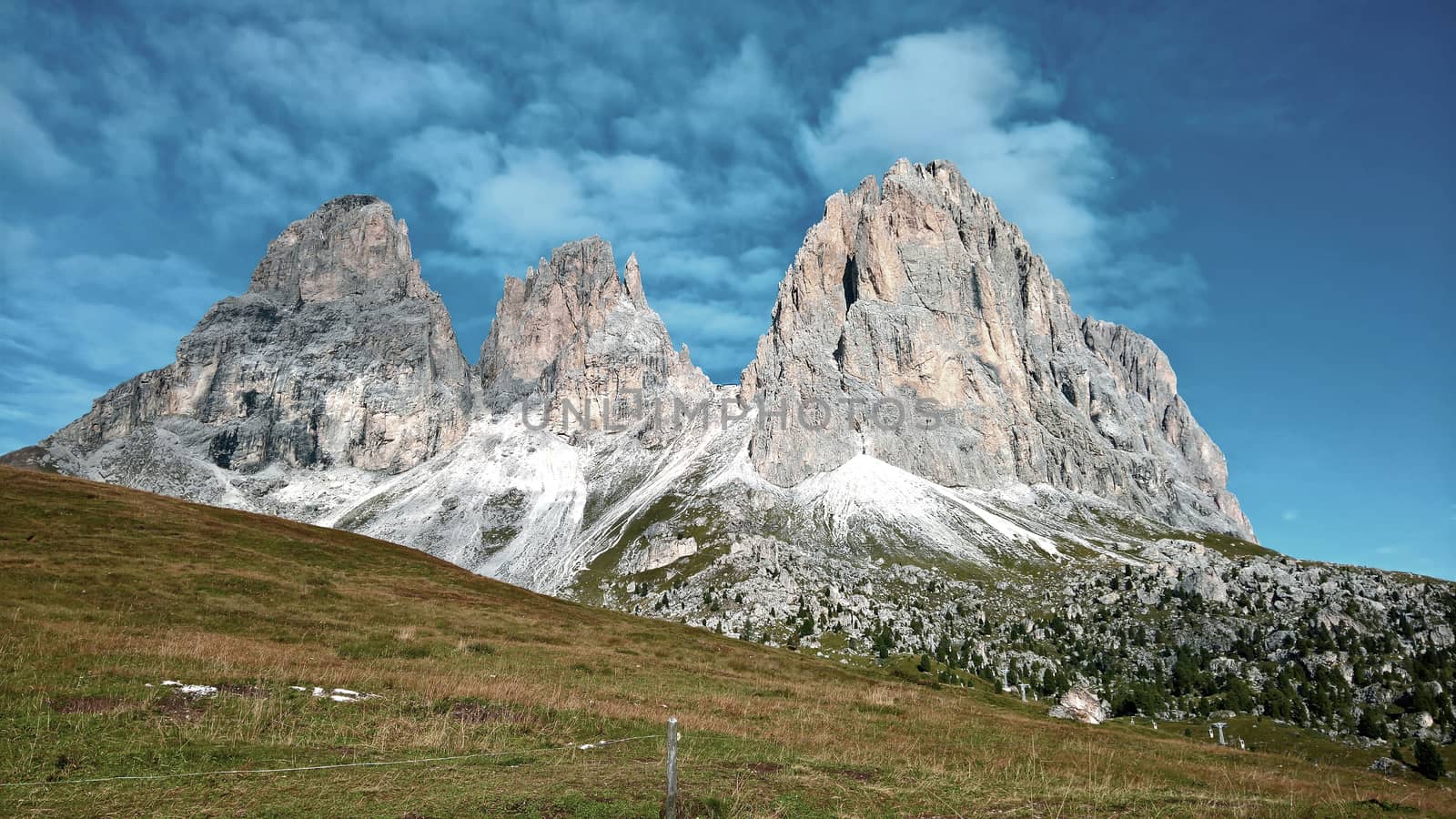 Trentino Alto - Adige, Italy - 06/15/2020: cenic alpine place with magical Dolomites mountains in background, amazing clouds and blue sky in Trentino Alto Adige region, Italy, Europe