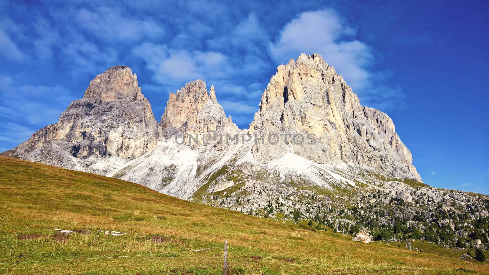 Trentino Alto - Adige, Italy - 06/15/2020: cenic alpine place with magical Dolomites mountains in background, amazing clouds and blue sky in Trentino Alto Adige region, Italy, Europe