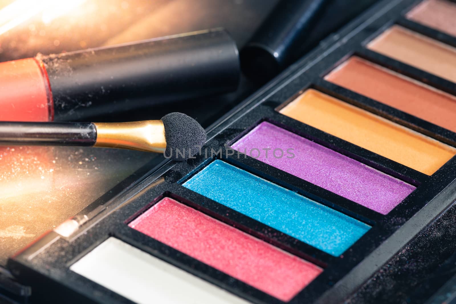 Closeup colorful makeup products detail by Natstocker
