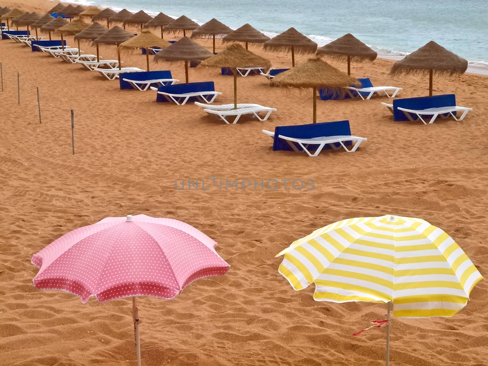 Umbrellas and sunbeds at an empty beach