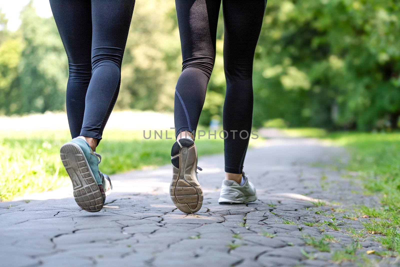 Female running feet in sport shoes by wdnet_studio