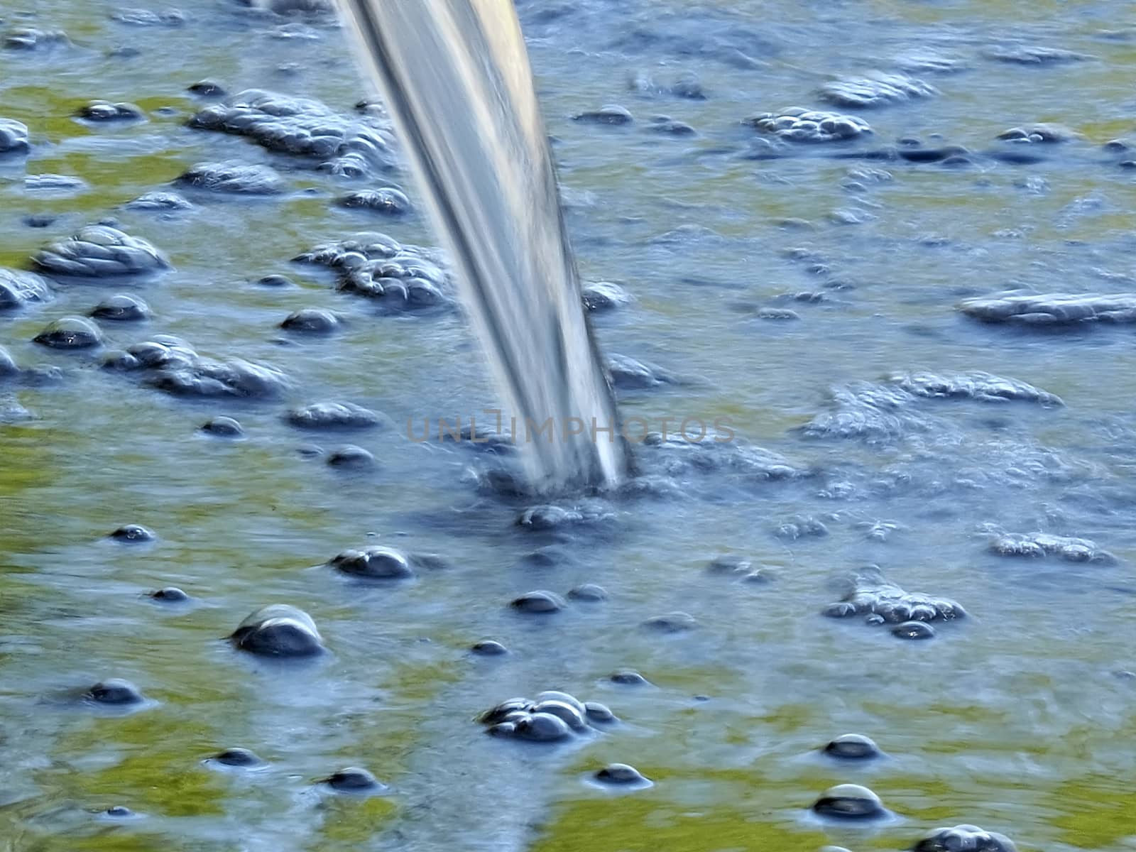 Closeup of running water making bubbles by Stimmungsbilder
