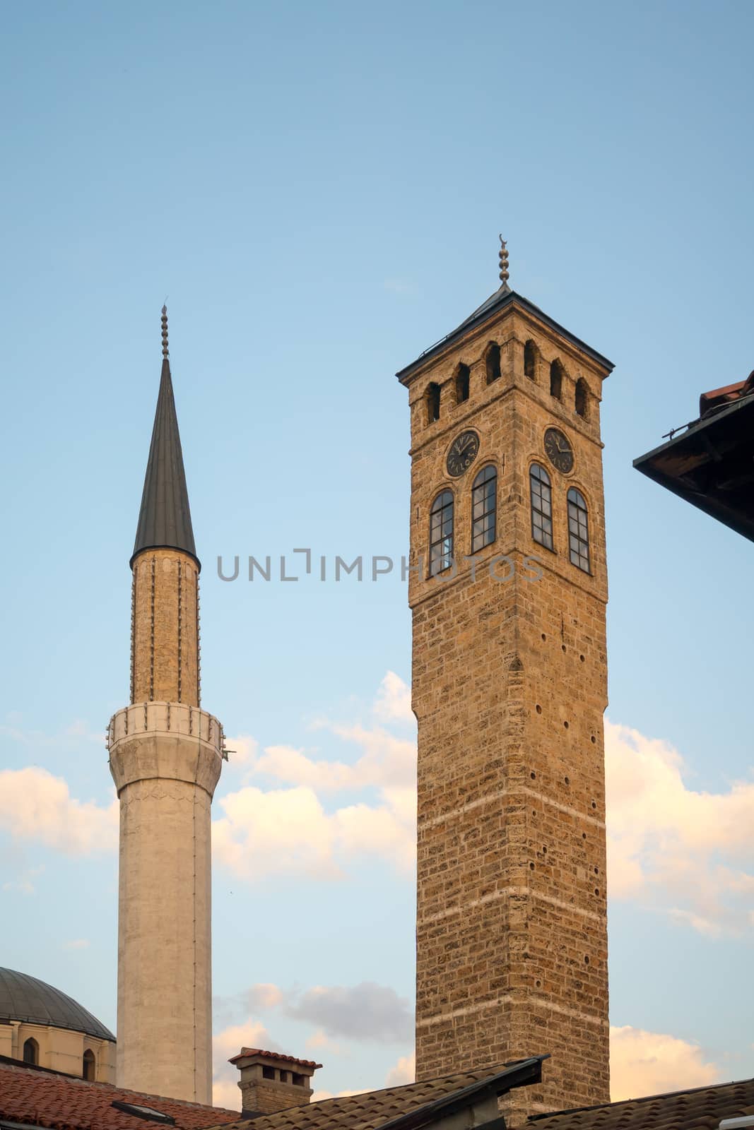 The minaret of the Ferhadija Mosque, and a clock tower, in Sarajevo, Bosnia and Herzegovina