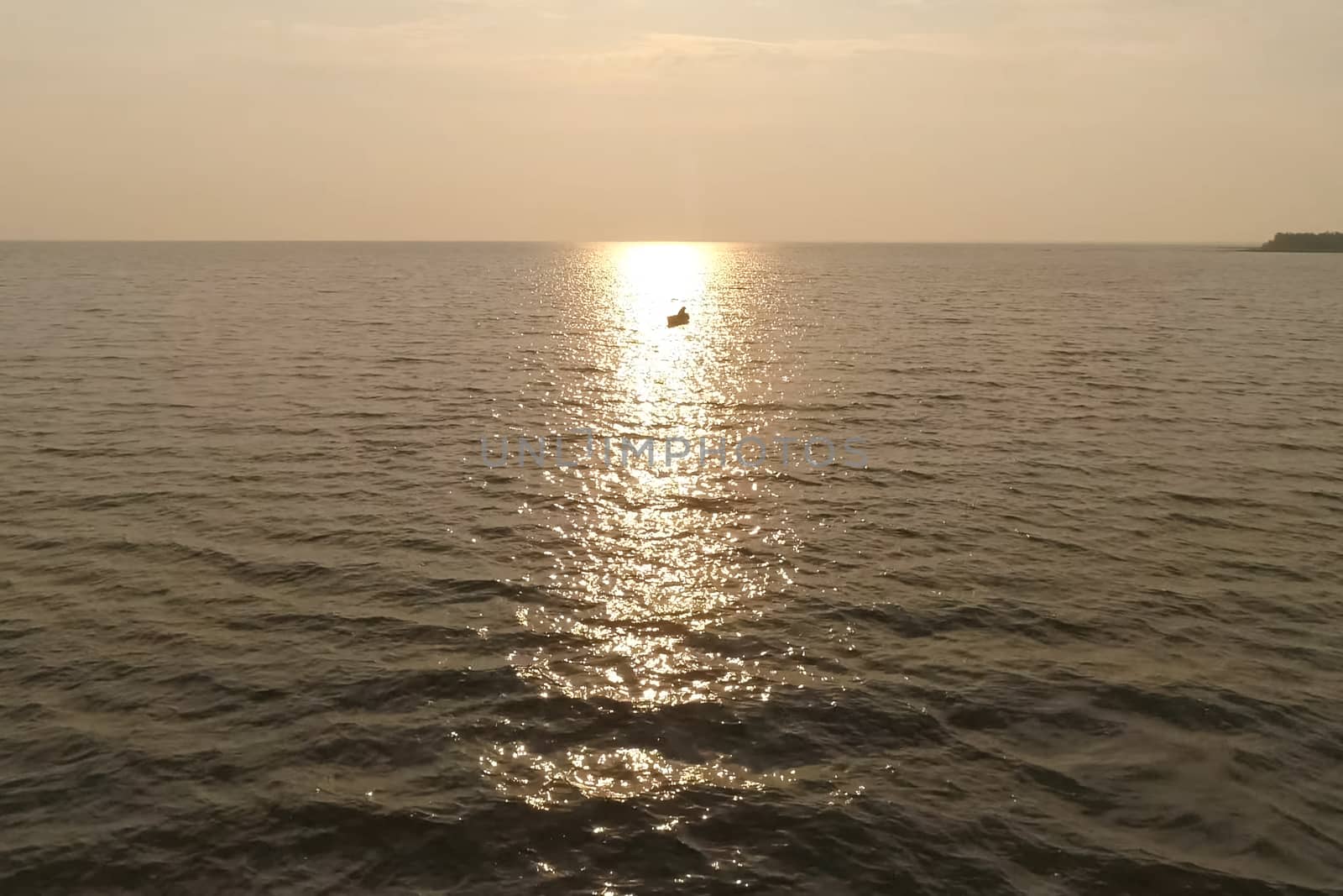 fisherman in a boat in the sea against the sunset. by DePo