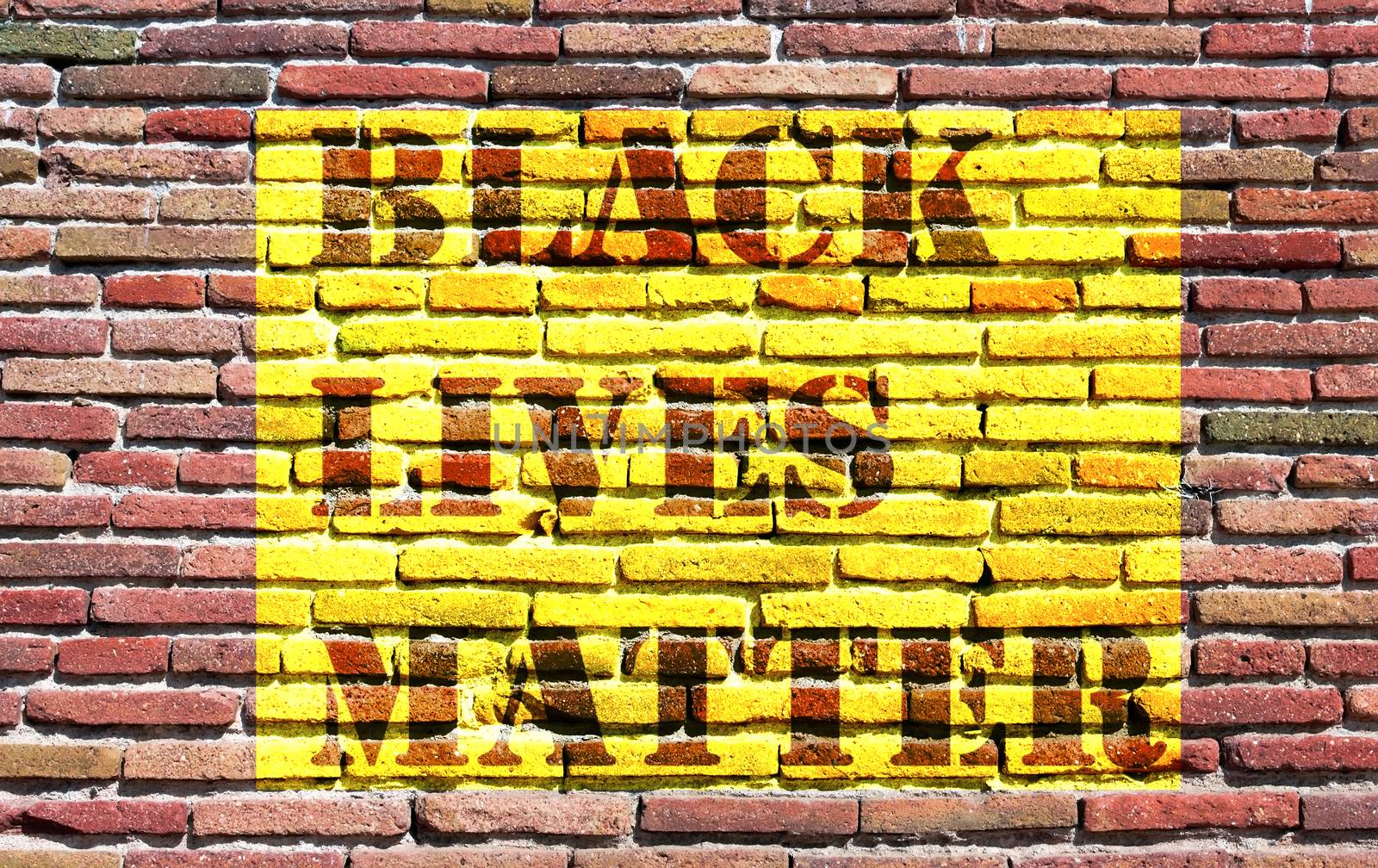 Black Lives Matter slogan liberation banner designs yellow stencil wall from old red brick pattern brickwork