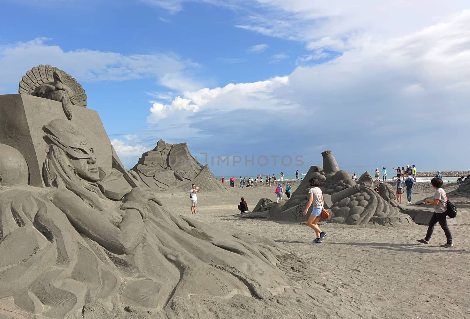 KAOHSIUNG, TAIWAN -- AUGUST 12, 2015: Visitors take photos of art objects at the 2015 Sand Sculpture Festival on Chijin Island.
