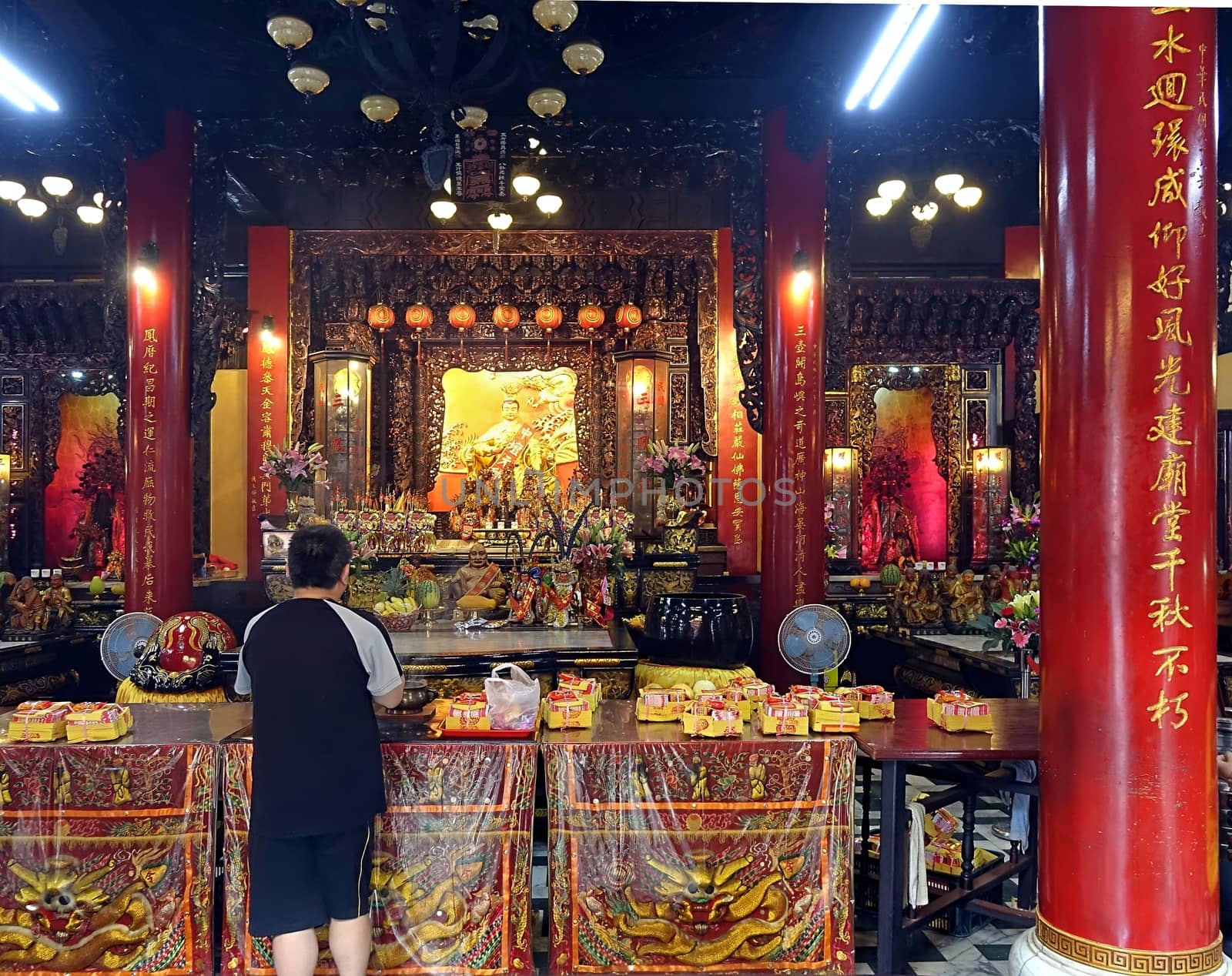 KAOHSIUNG, TAIWAN -- AUGUST 15, 2015: A man prays at the altar of the Sanfeng Temple, which is one of the oldest temples in Kaohsiung, dating back 300 years.