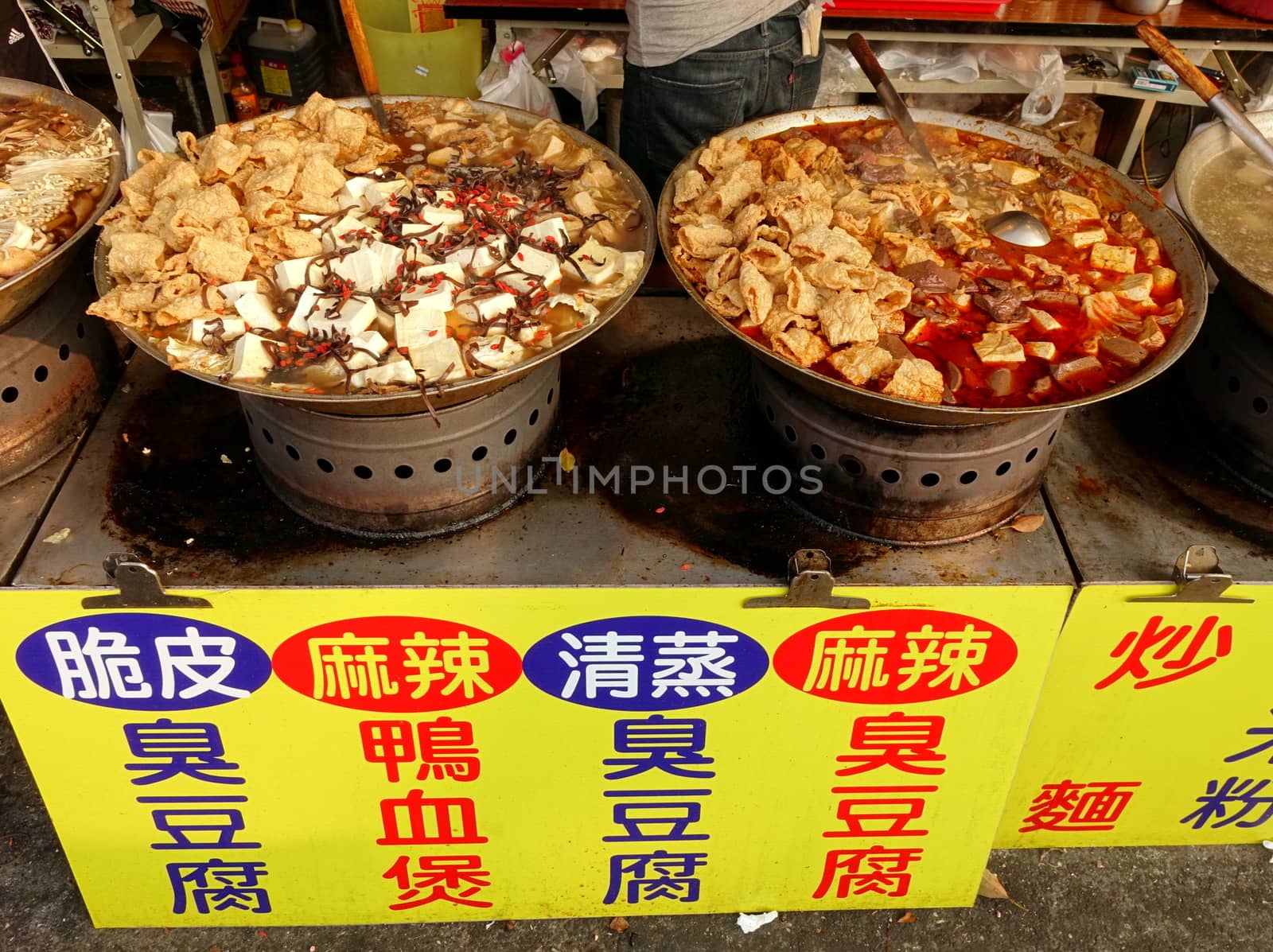 KAOHSIUNG, TAIWAN -- OCTOBER 15, 2016: An outdoor food stall advertises hot pot cooked with tofu, duck blood cakes, chili and Chinese medicinal herbs.