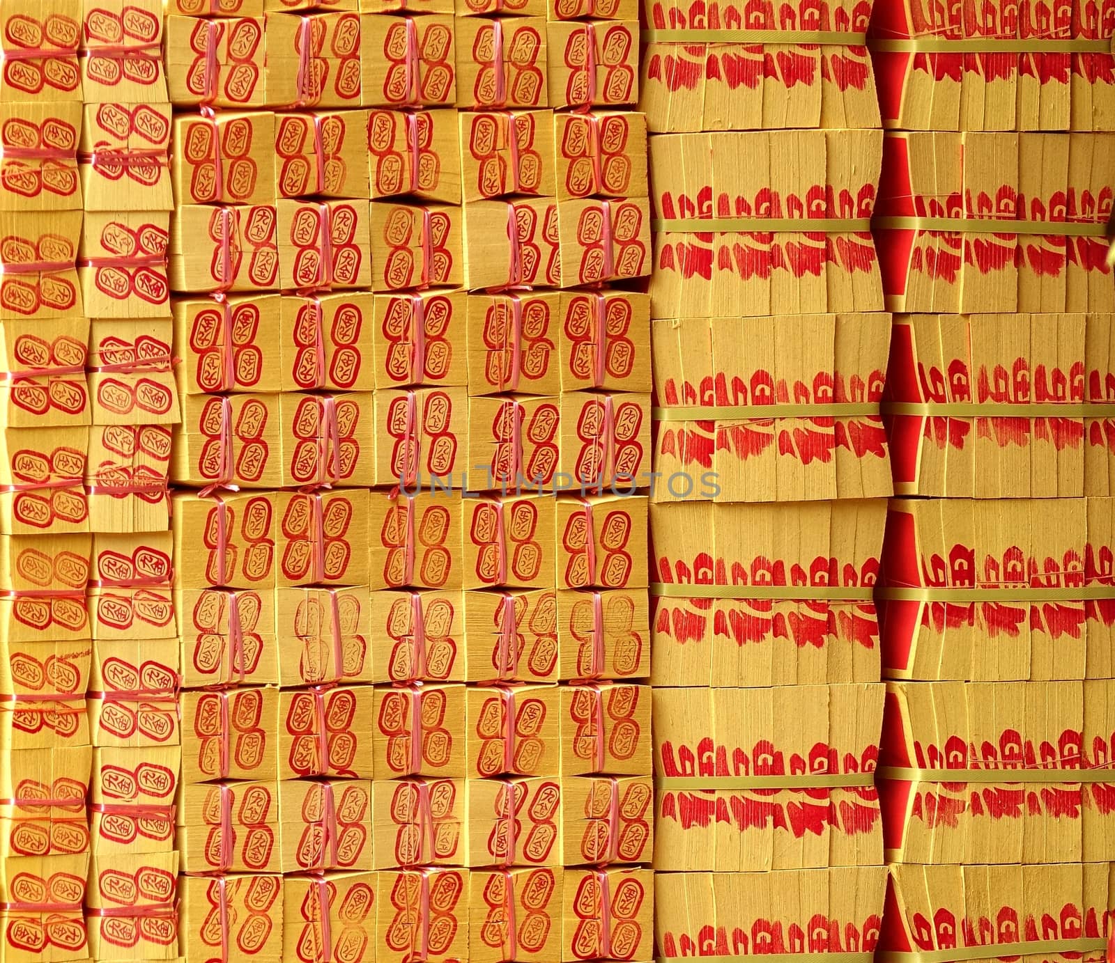 KAOHSIUNG, TAIWAN -- MARCH 16, 2014: A large stack of joss paper is prepared for burnt offerings at a local religious ceremony.