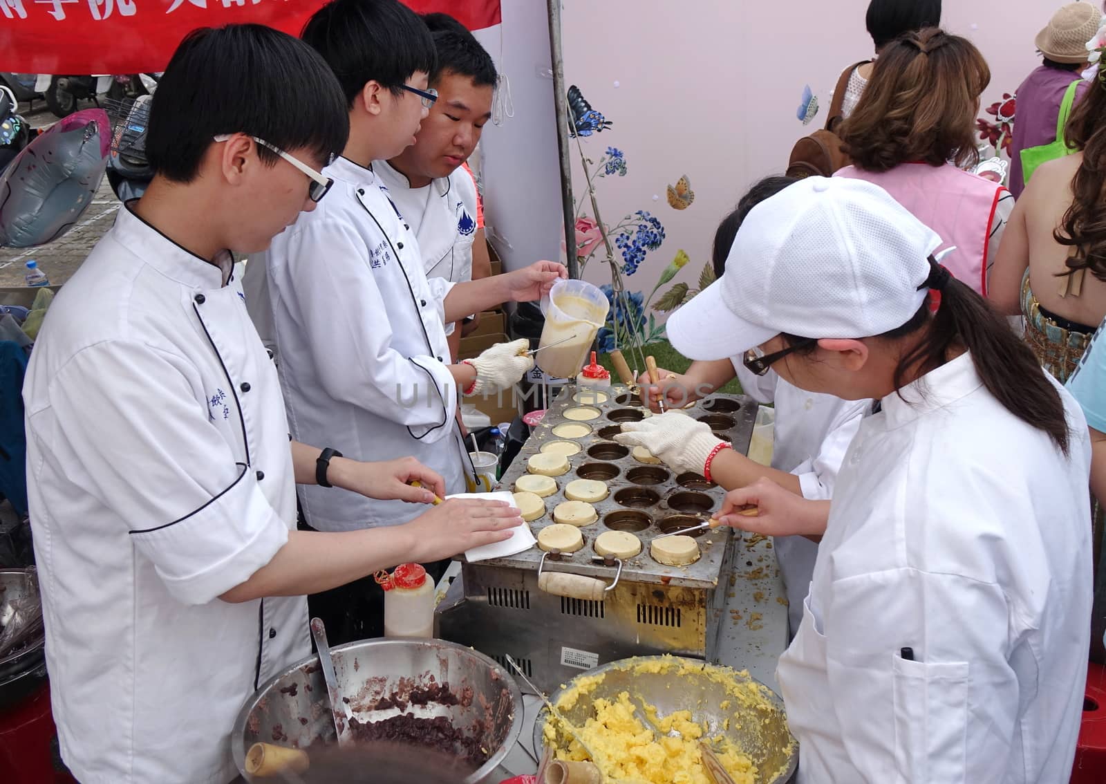 KAOHSIUNG, TAIWAN -- DECEMBER 8, 2018: Cooking school students make red bean cakes, or Imagawayaki, as the Japanese call it, a popular sweet food in Taiwan.