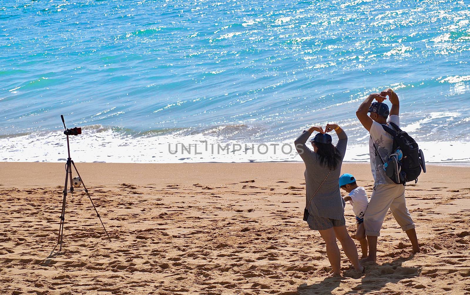 Family is taking a selfie at the beach
