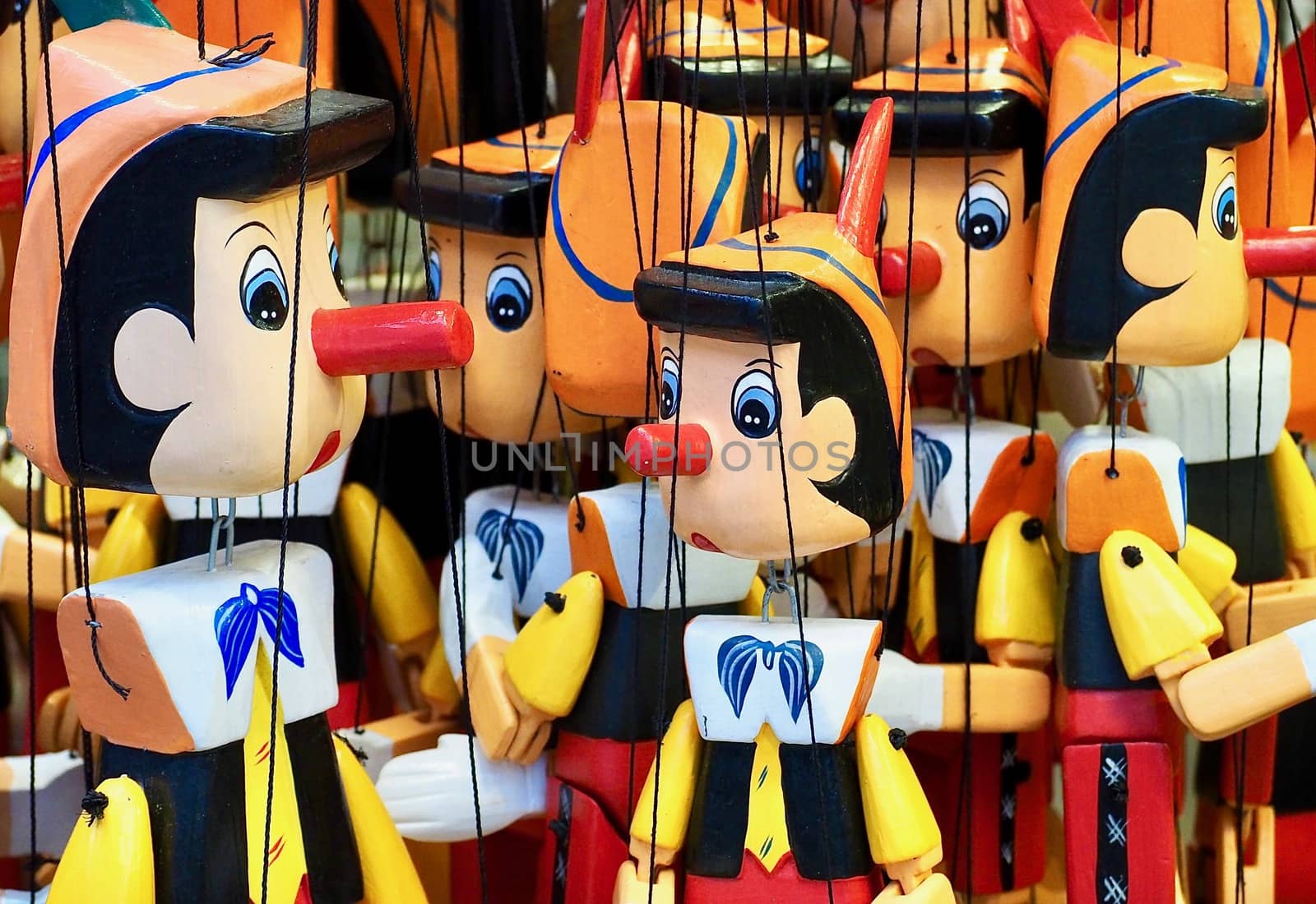 Many wooden Pinocchio puppets at a market by Stimmungsbilder