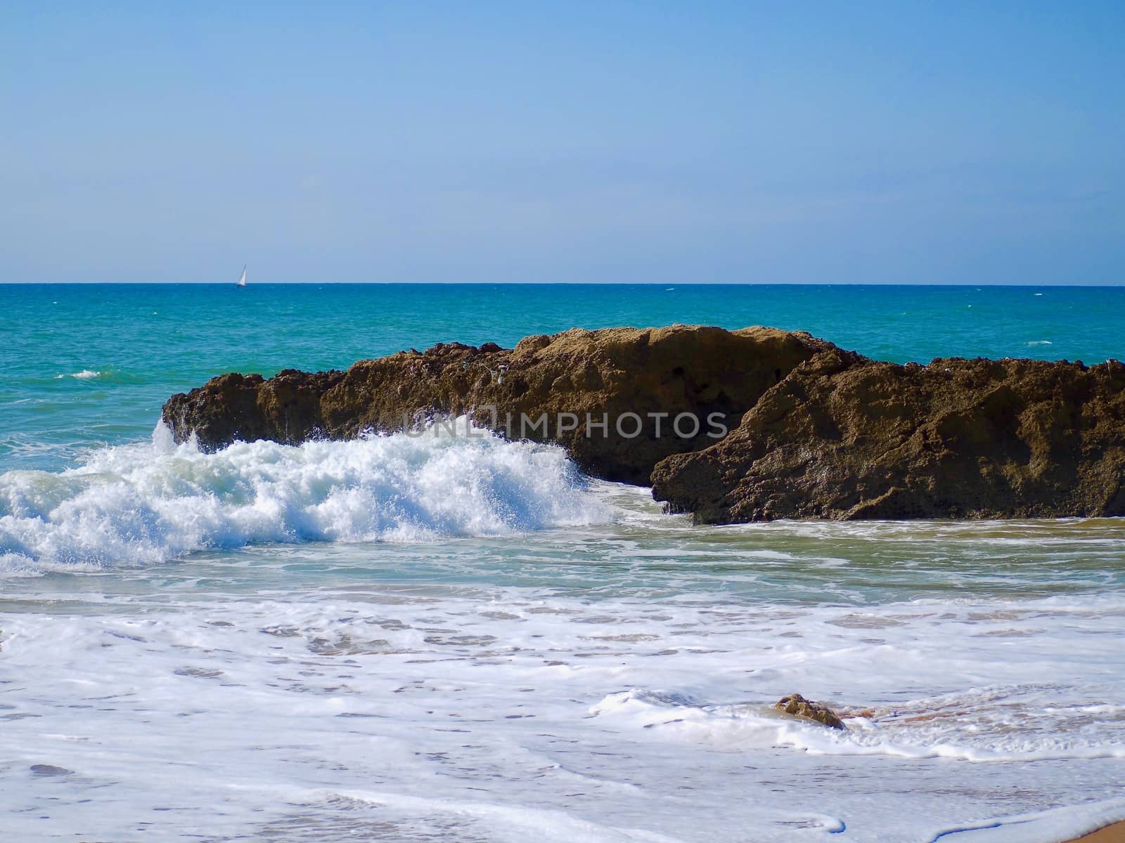 Bic rocks with waves in turquoise ocean