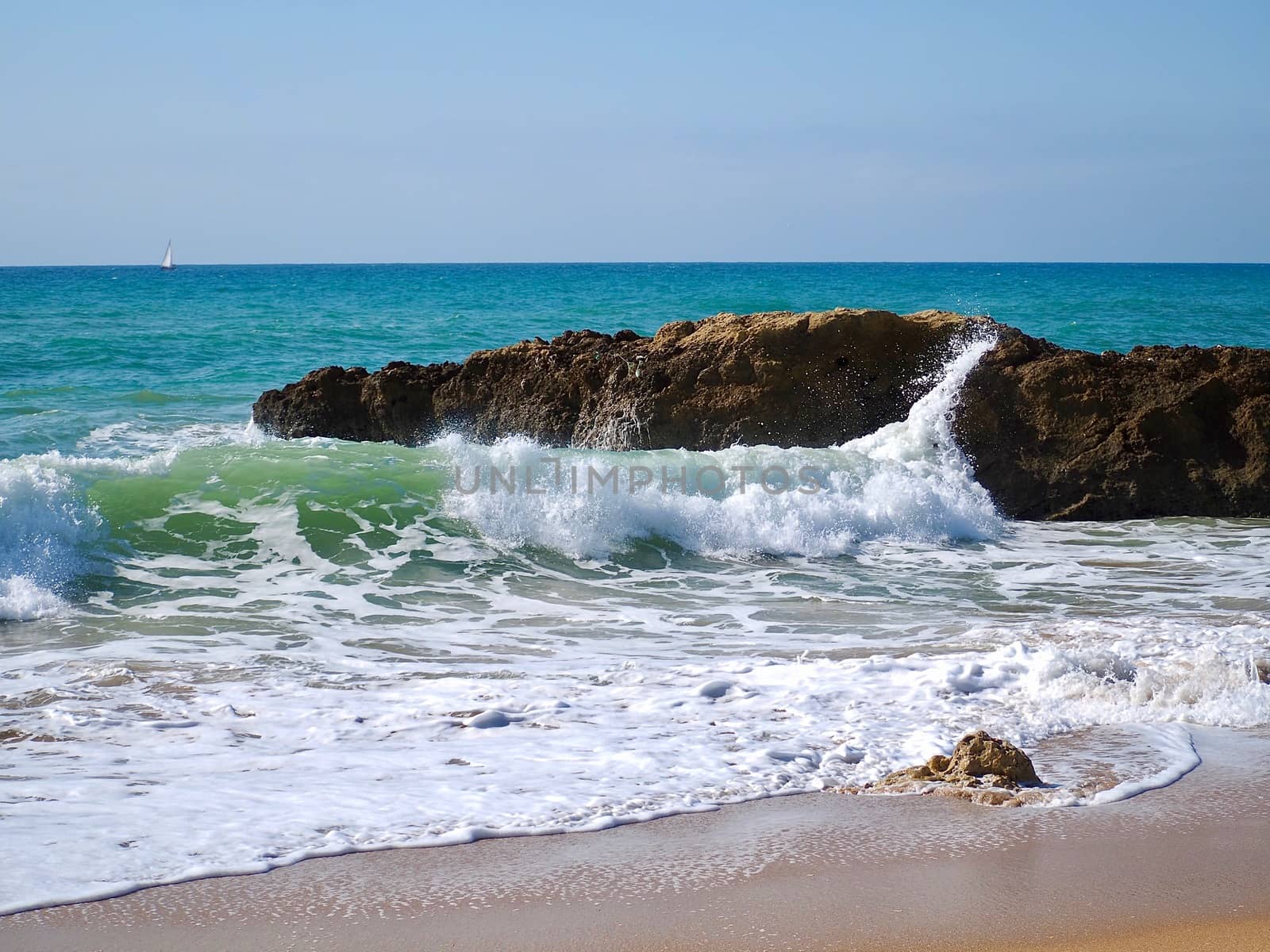 Nature photo of rocks with waves in blue ocean by Stimmungsbilder
