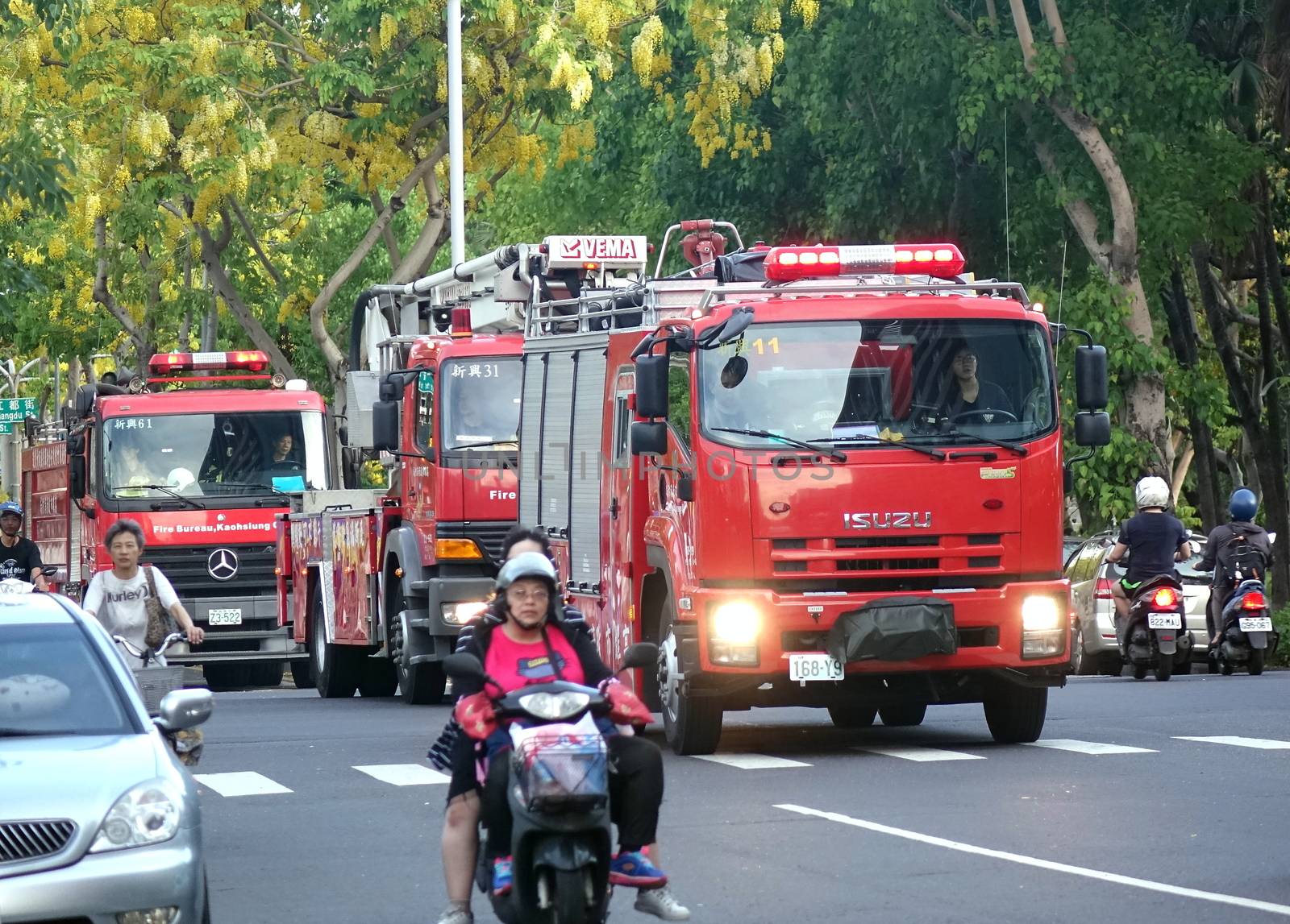 KAOHSIUNG, TAIWAN -- MAY 26, 2018: Three fire truck are on an early evening rescue mission in the city of Kaohsiung.
