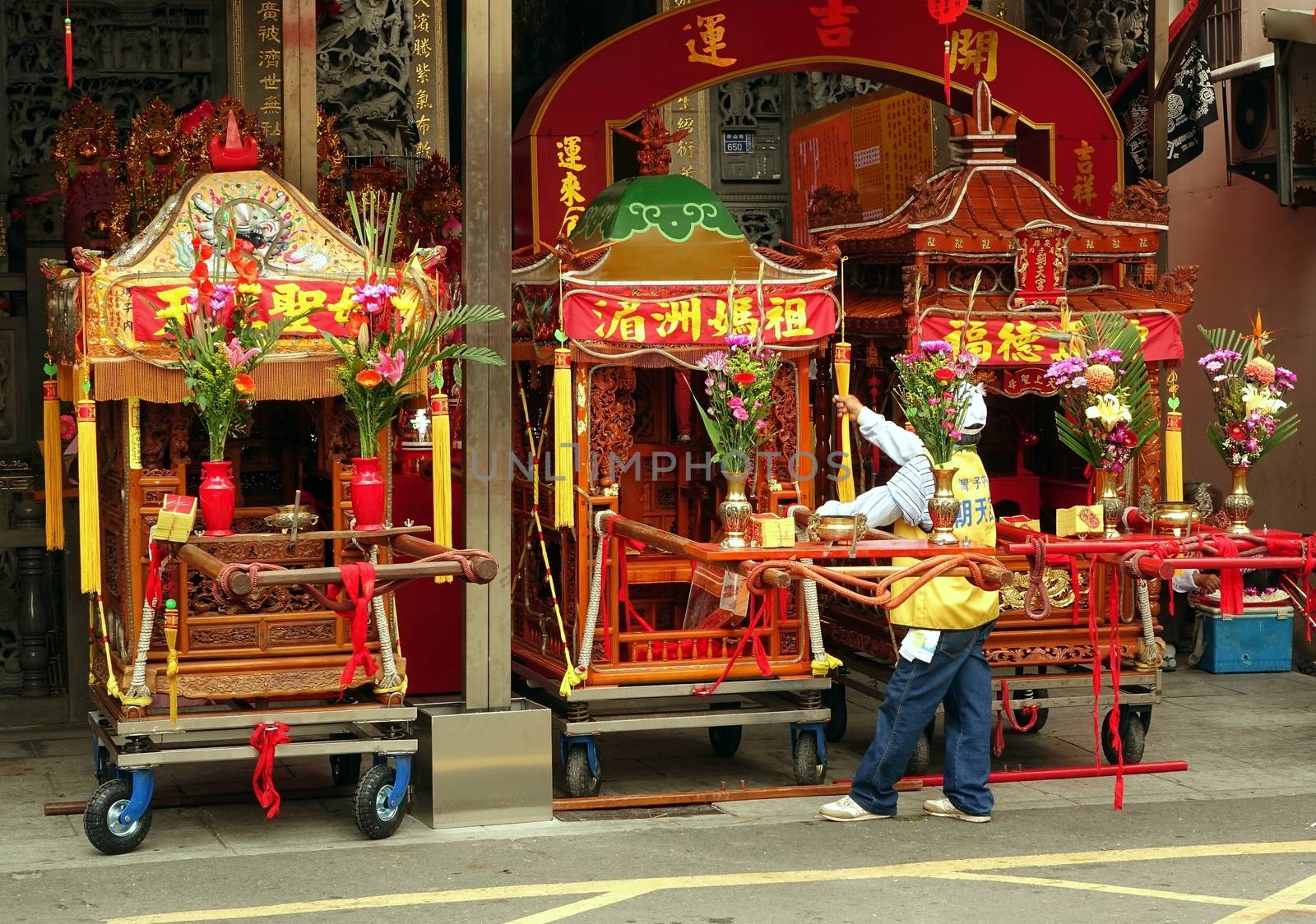 KAOHSIUNG, TAIWAN -- APRIL 19, 2014: Three sedan chairs which contain religious objects are being prepared for a ceremony in honor of the goddess Matsu.