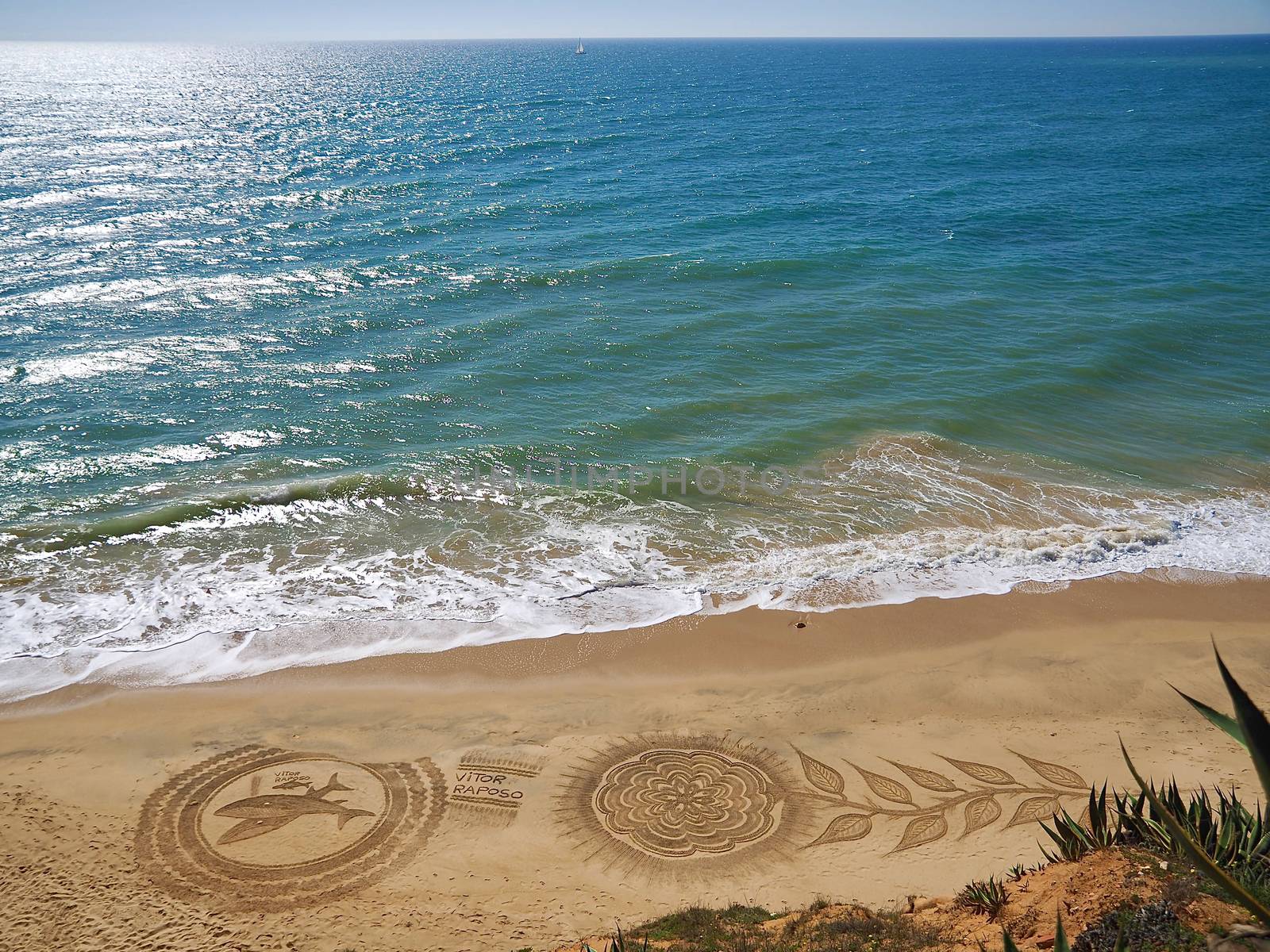 Beautiful beach mandala with a flower and dolphins in Albufeira in Portugal by Stimmungsbilder