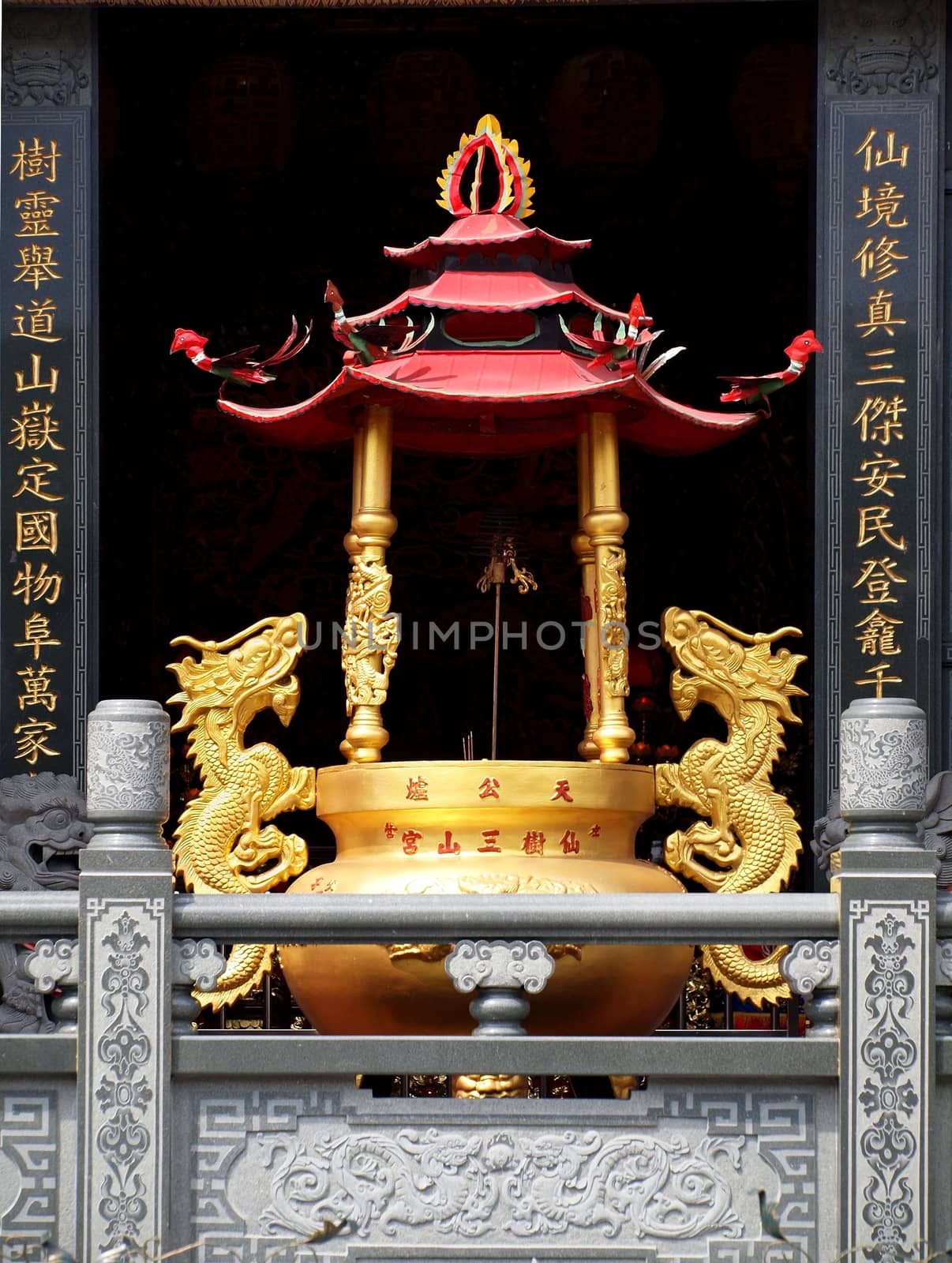 KAOHSIUNG, TAIWAN -- OCTOBER 13, 2013: This elaborate bronze cauldron that is used as an incense burner is located in the Tian Fu Temple in Kaohsiung City.