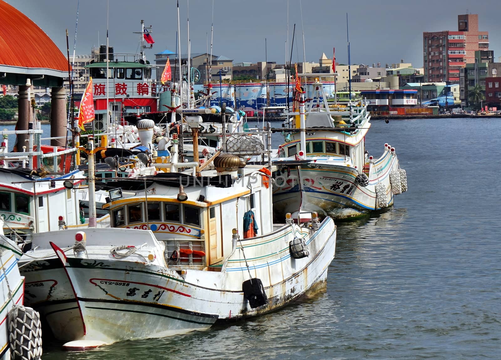 KAOHSIUNG, TAIWAN -- JUNE 27, 2019: Traditional Chinese fishing boats are anchored at the Gushan Ferry Pier.
