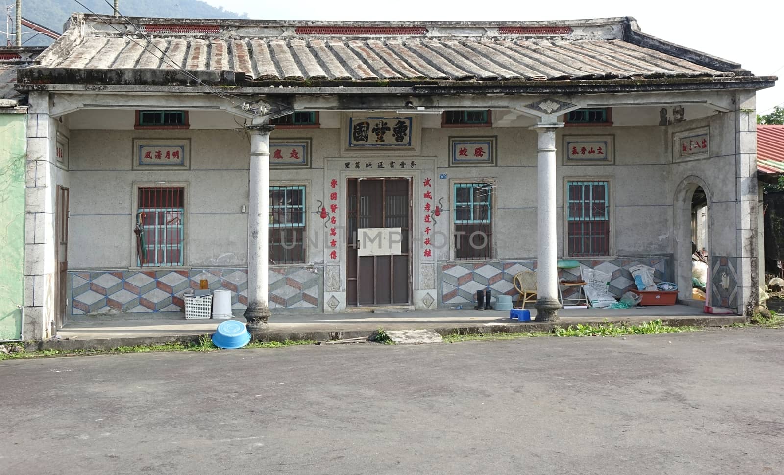 PINGTUNG, TAIWAN -- FEBRUARY 5, 2016: A traditional Chinese farm house with auspicious saying and quotations around the door and above the windows.