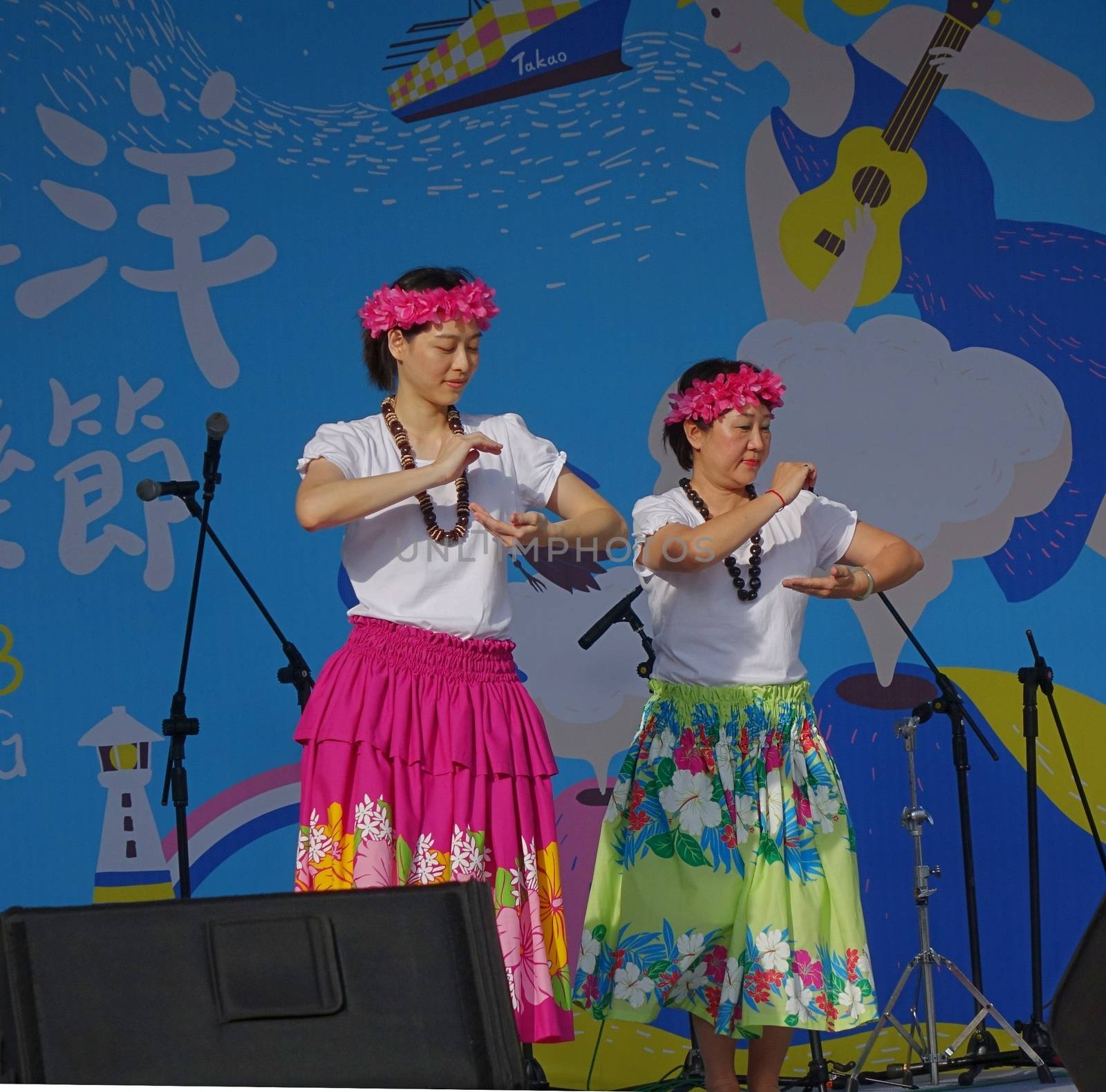 KAOHSIUNG, TAIWAN -- APRIL 23, 2016: Two unidentified dancers performs a Hawaiian dance at the 1st Pacific Rim Ukulele Festival, a free outdoor event.