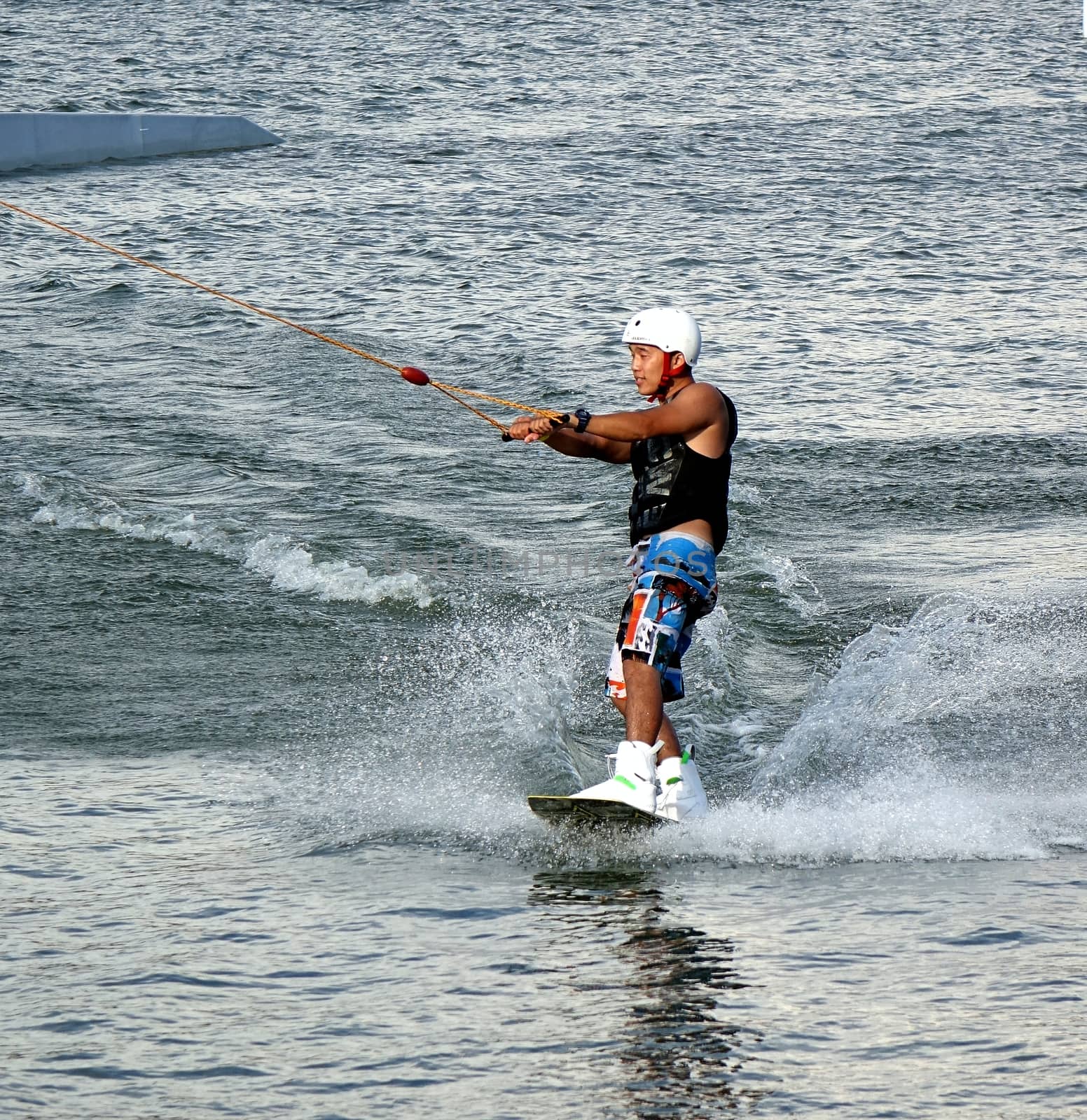 KAOHSIUNG, TAIWAN -- MAY 25, 2014: An unidentified male enjoys wakeboarding on the Lotus Lake in Kaohsiung.