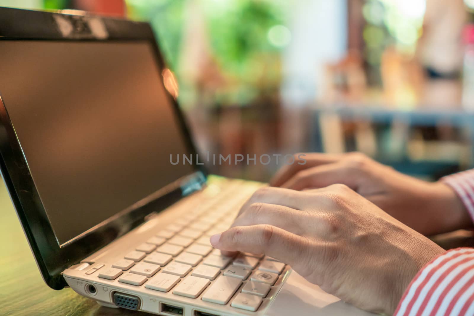 Woman hand using laptop to work study on work desk with clean nature background background. Business, financial, trade stock maket and social network concept.